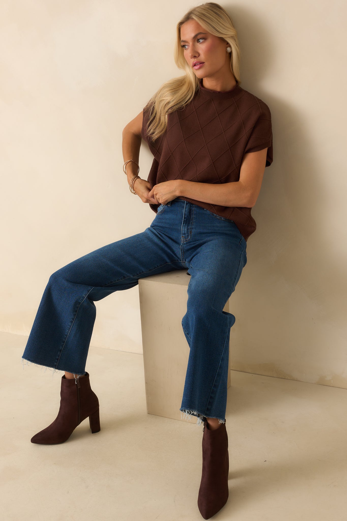 Brown sweater with crew neckline featuring rolled hem, short dolman sleeves, and straight bottom hem.