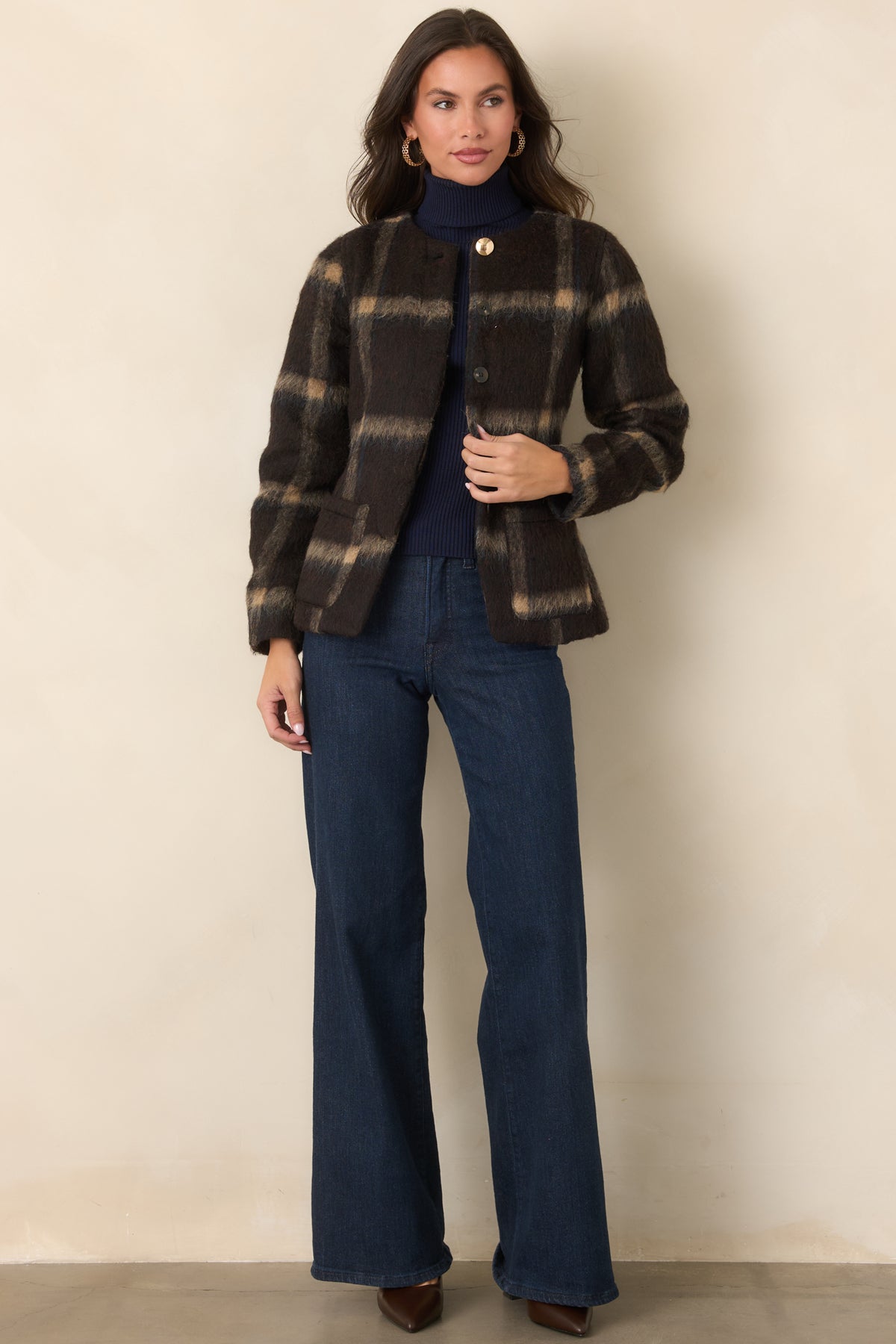 Brown, tan, and navy plaid jacket with a gently fitted silhouette and concealed button front.