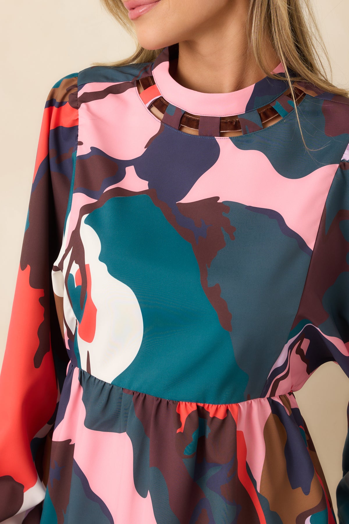 Brown velvet woven neckline trim contrasts with the colorful botanical print and softly gathered fabric of the dress.