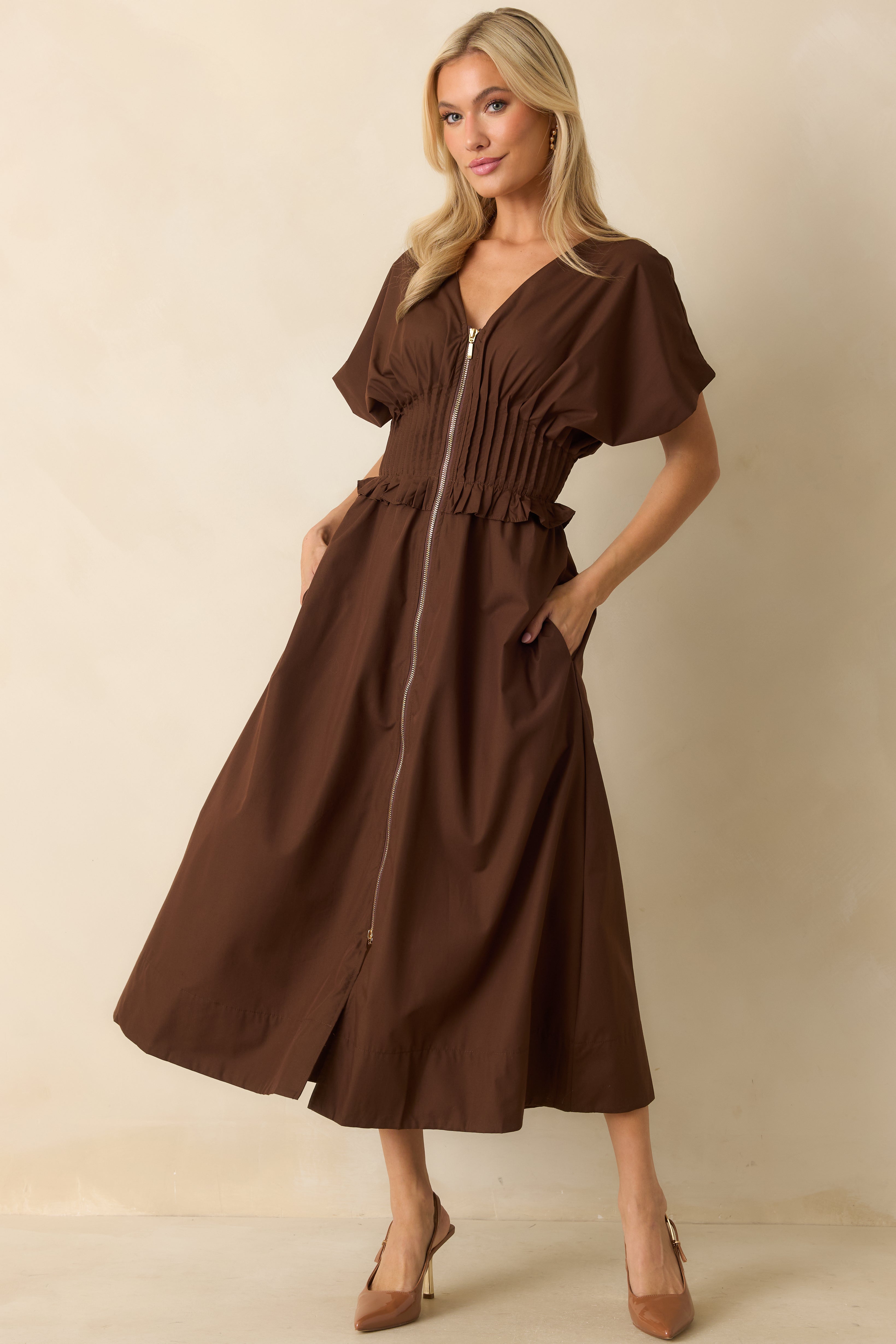 Front view of the brown woven maxi dress featuring a V-neckline, short sleeves, and a front zip closure with a relaxed A-line shape.