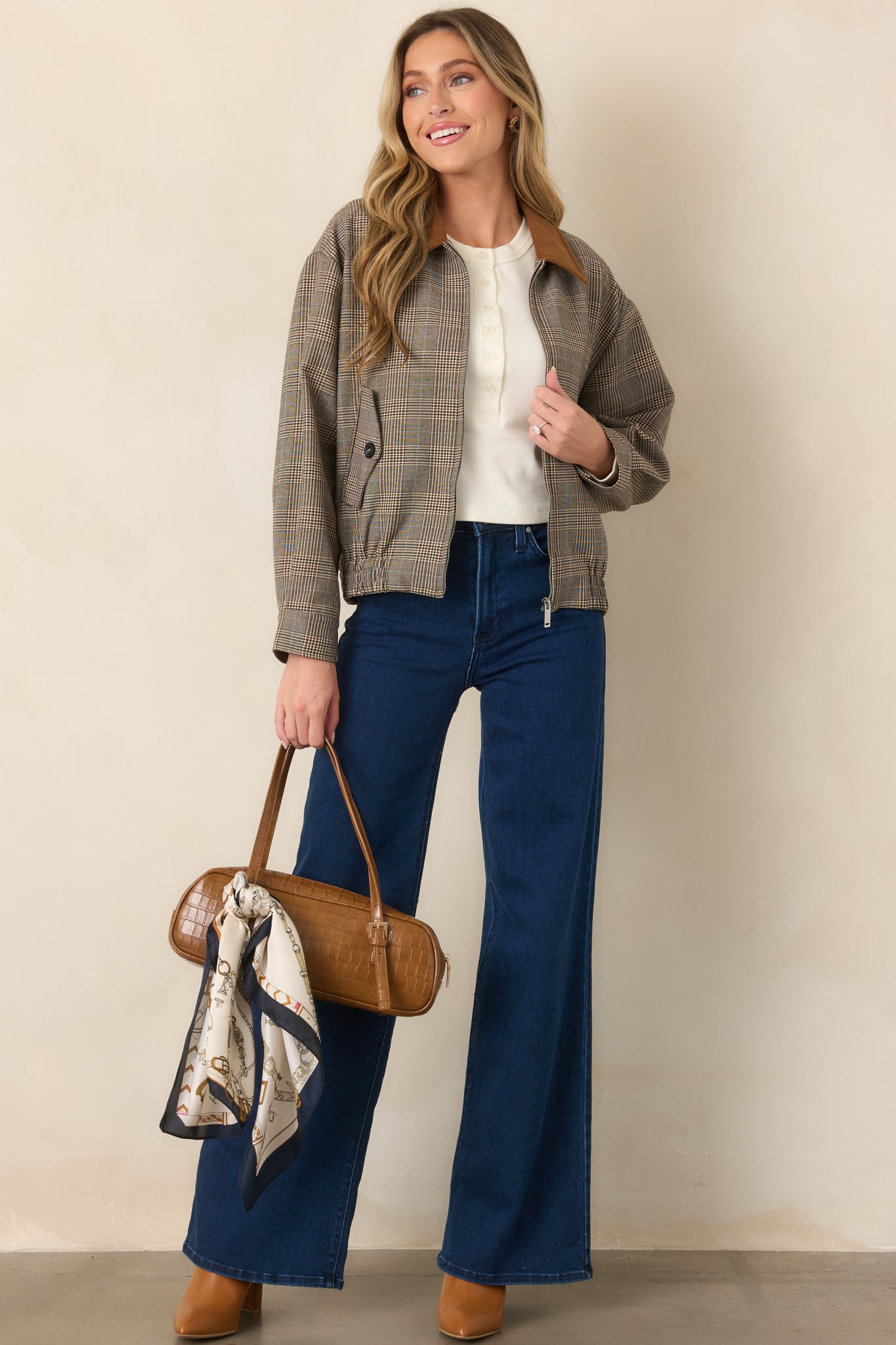 Brown woven plaid jacket with a zip-front closure, contrasting corduroy collar, functional flap pockets, and a gathered elastic hem.