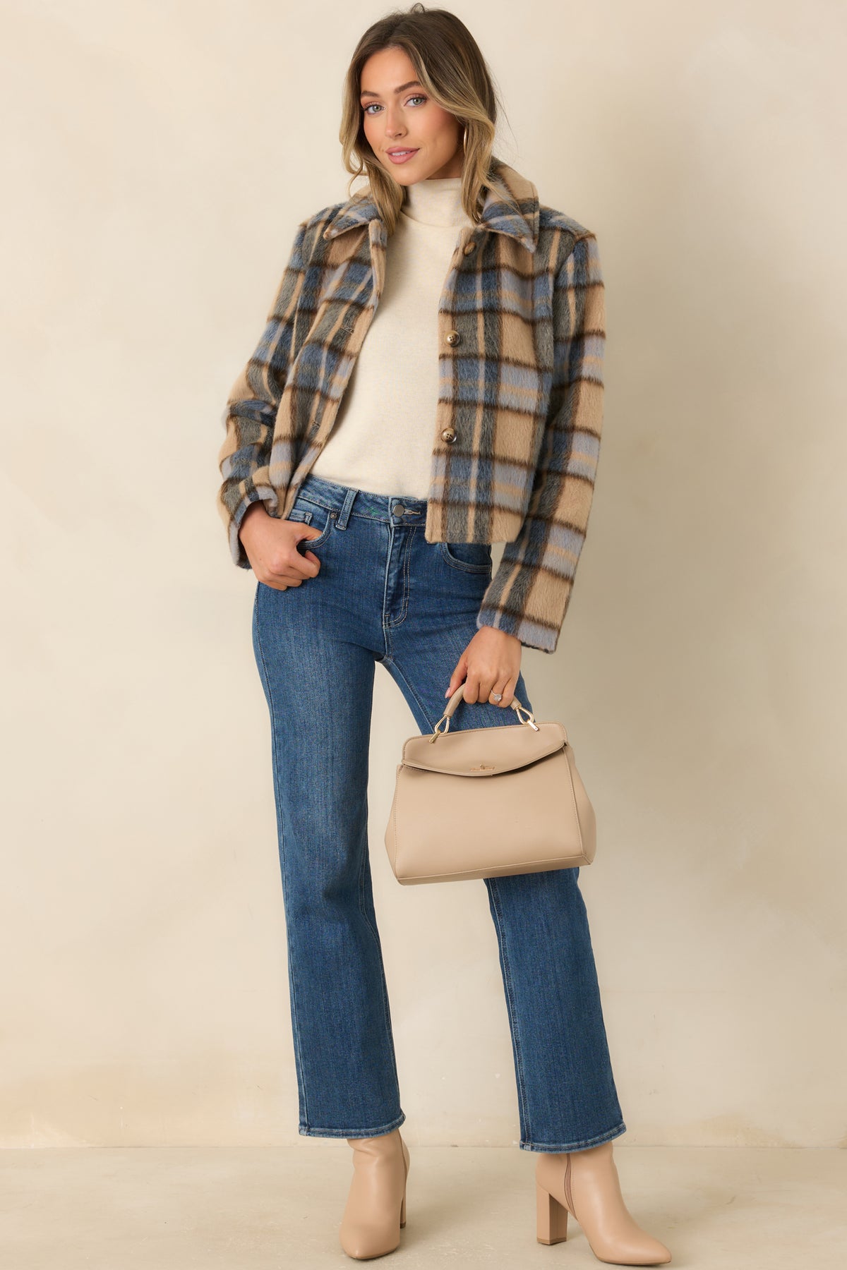 Brushed plaid jacket featuring a tailored cropped silhouette, long sleeves, and a button-front closure.