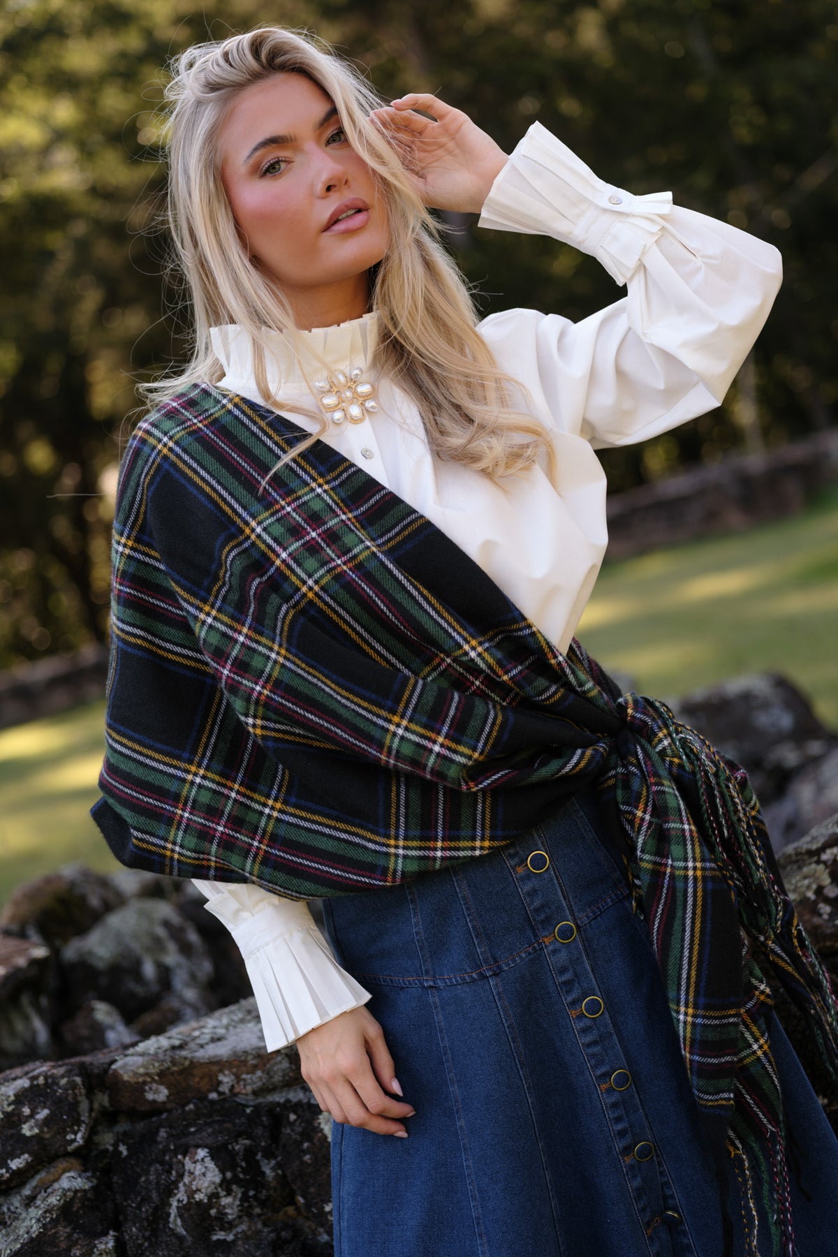Soft brushed plaid scarf featuring colorful intersecting stripes and textured fringe along both ends.