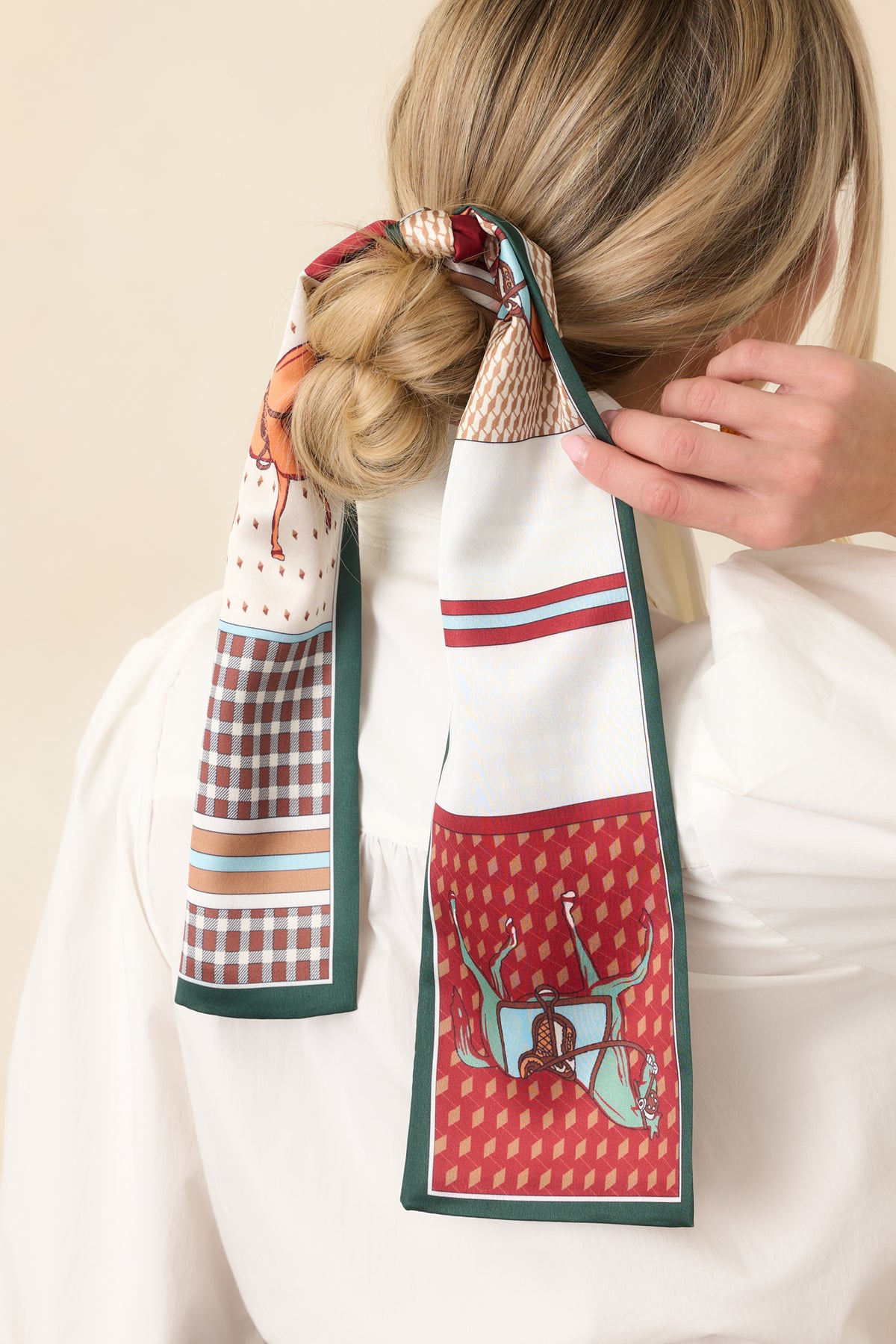 Burgundy and camel scarf with horse illustrations, checked sections, and intricate geometric designs.