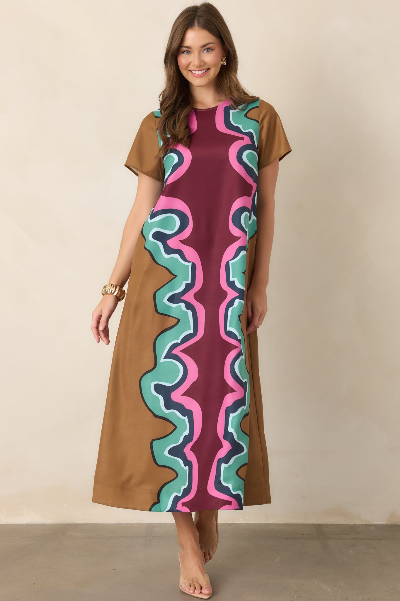 Statement maxi dress with an eye-catching serpentine pattern in rich burgundy and camel accented by seafoam green, navy, light blue, and pink.