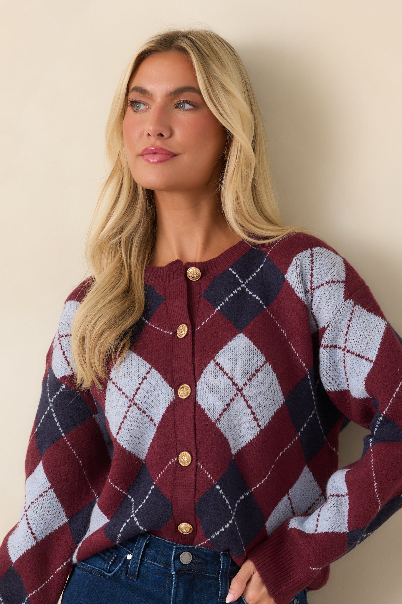 The front of this burgundy cardigan highlights the diamond pattern and refined gold-tone button details.