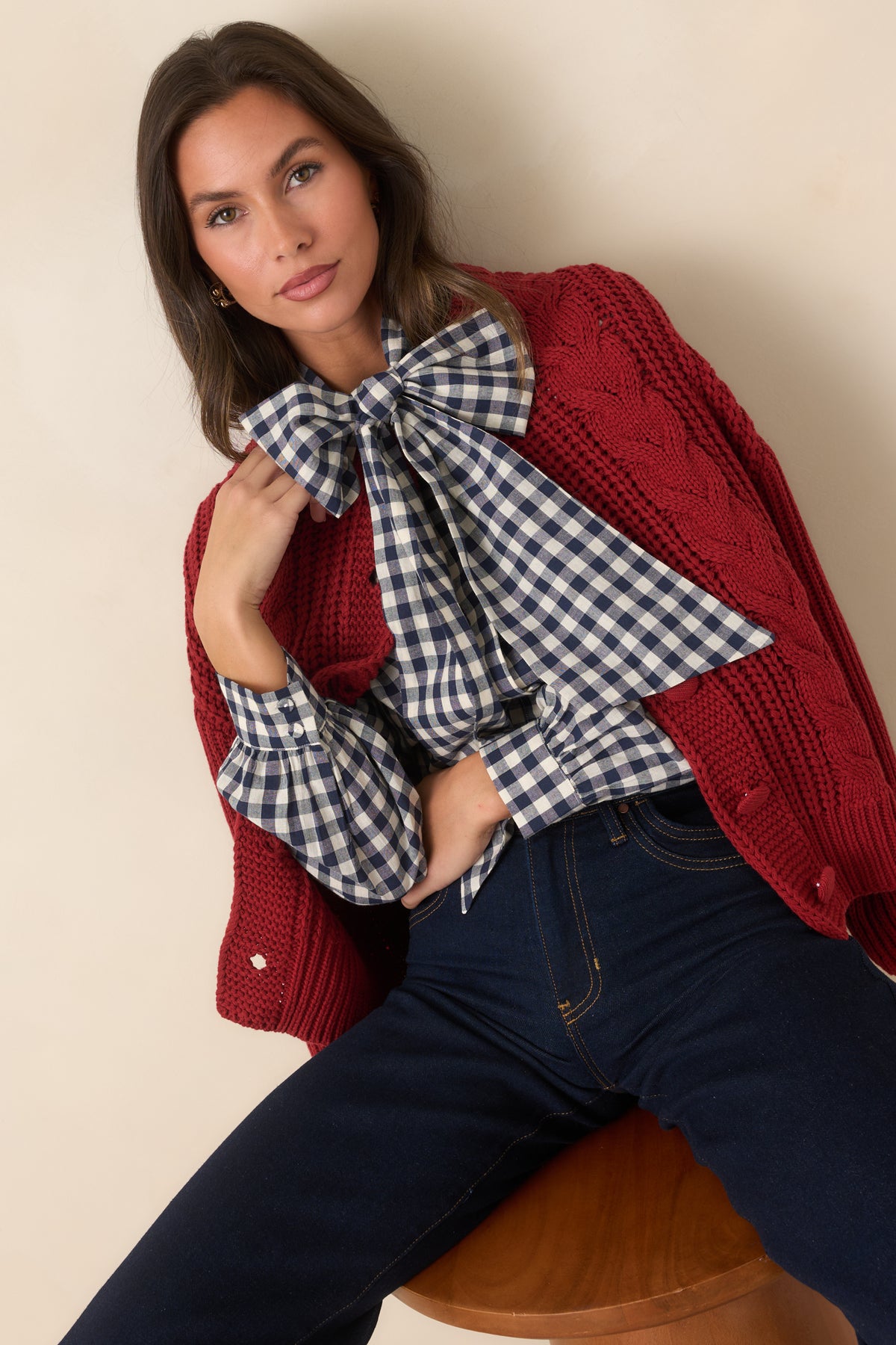 Rich burgundy knit cardigan showing the contrast between chunky cable and ribbed textures.