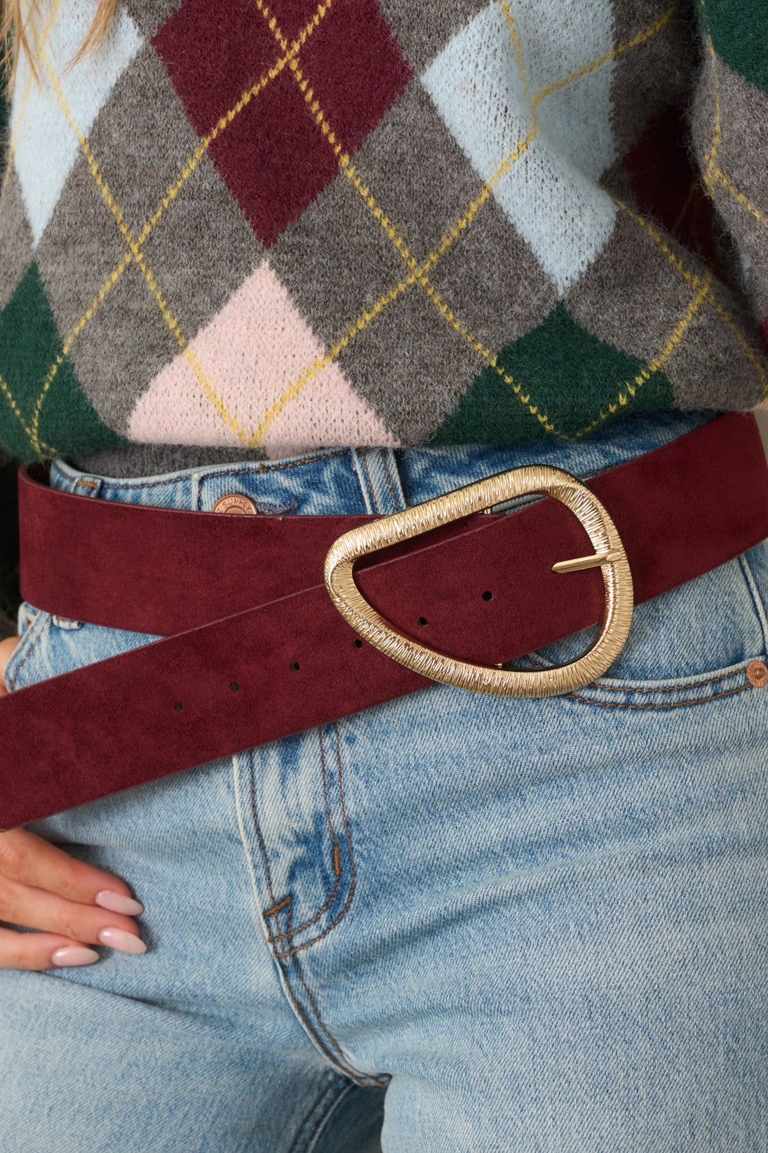 Burgundy faux suede belt featuring a dimensional wide band and textured gold-tone buckle.