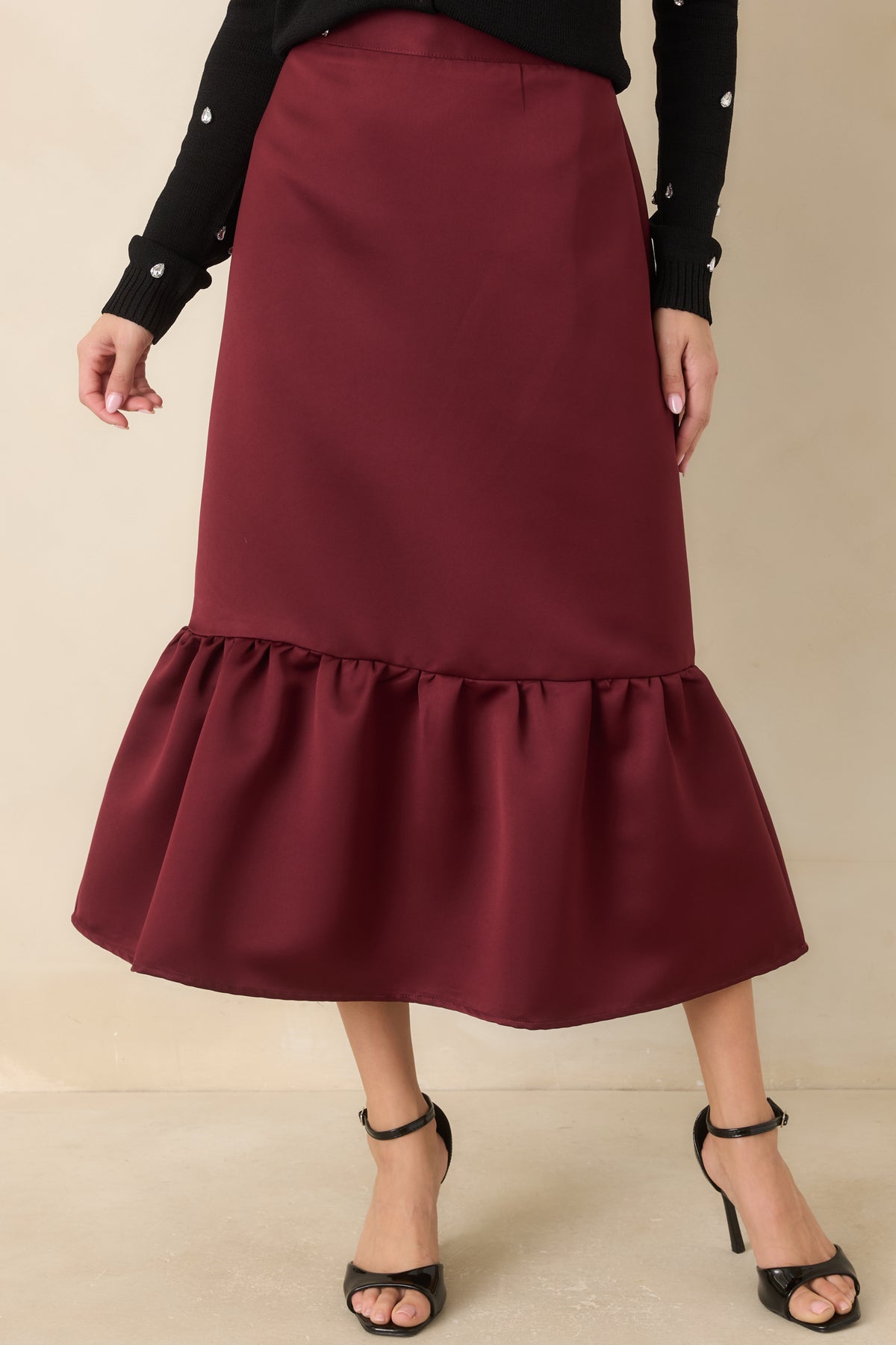 Burgundy fitted midi skirt with a gathered flounce that adds volume at the hem.