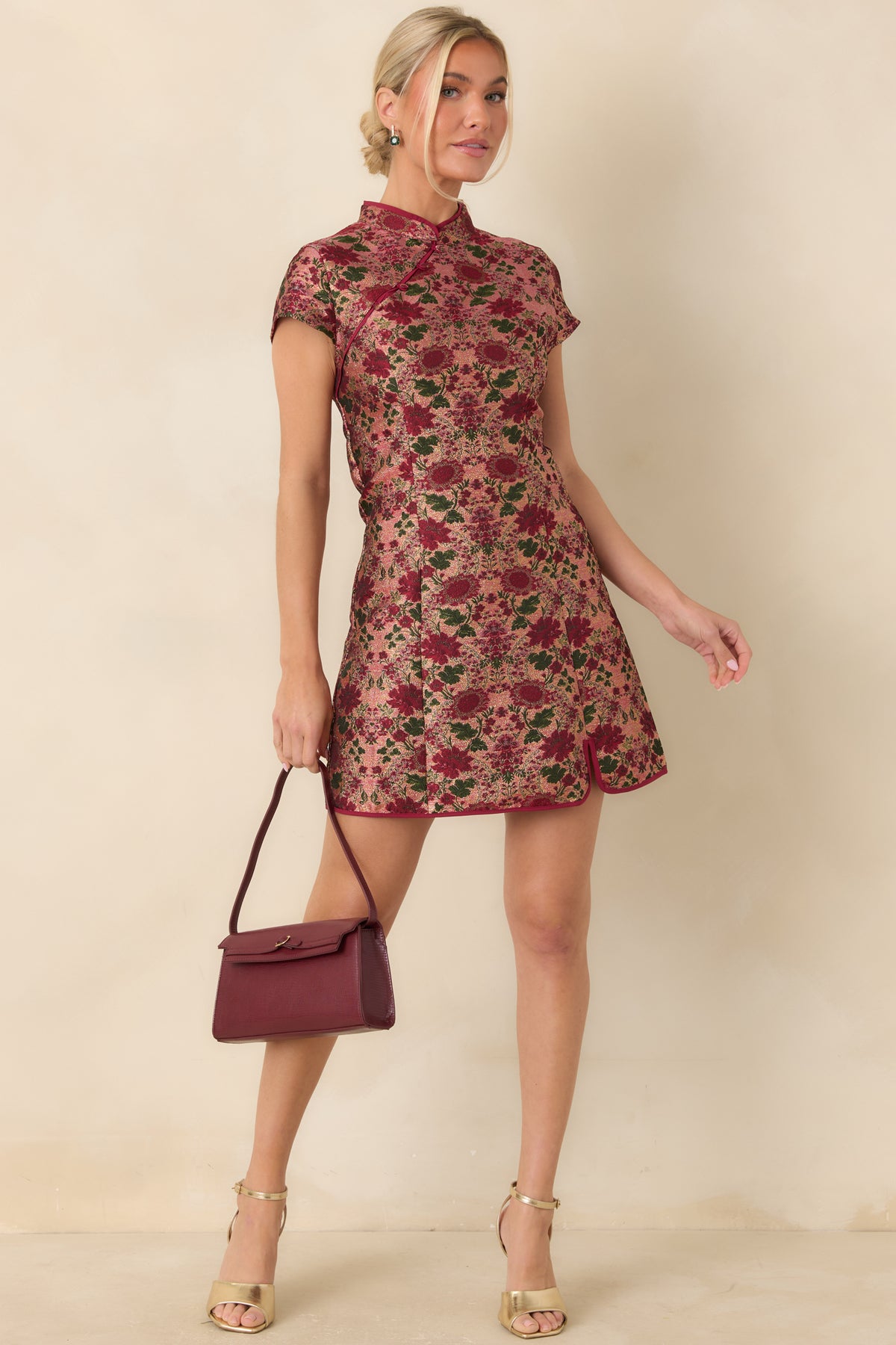Burgundy and deep green floral jacquard mini dress with a mandarin collar, covered buttons, and fitted bodice.