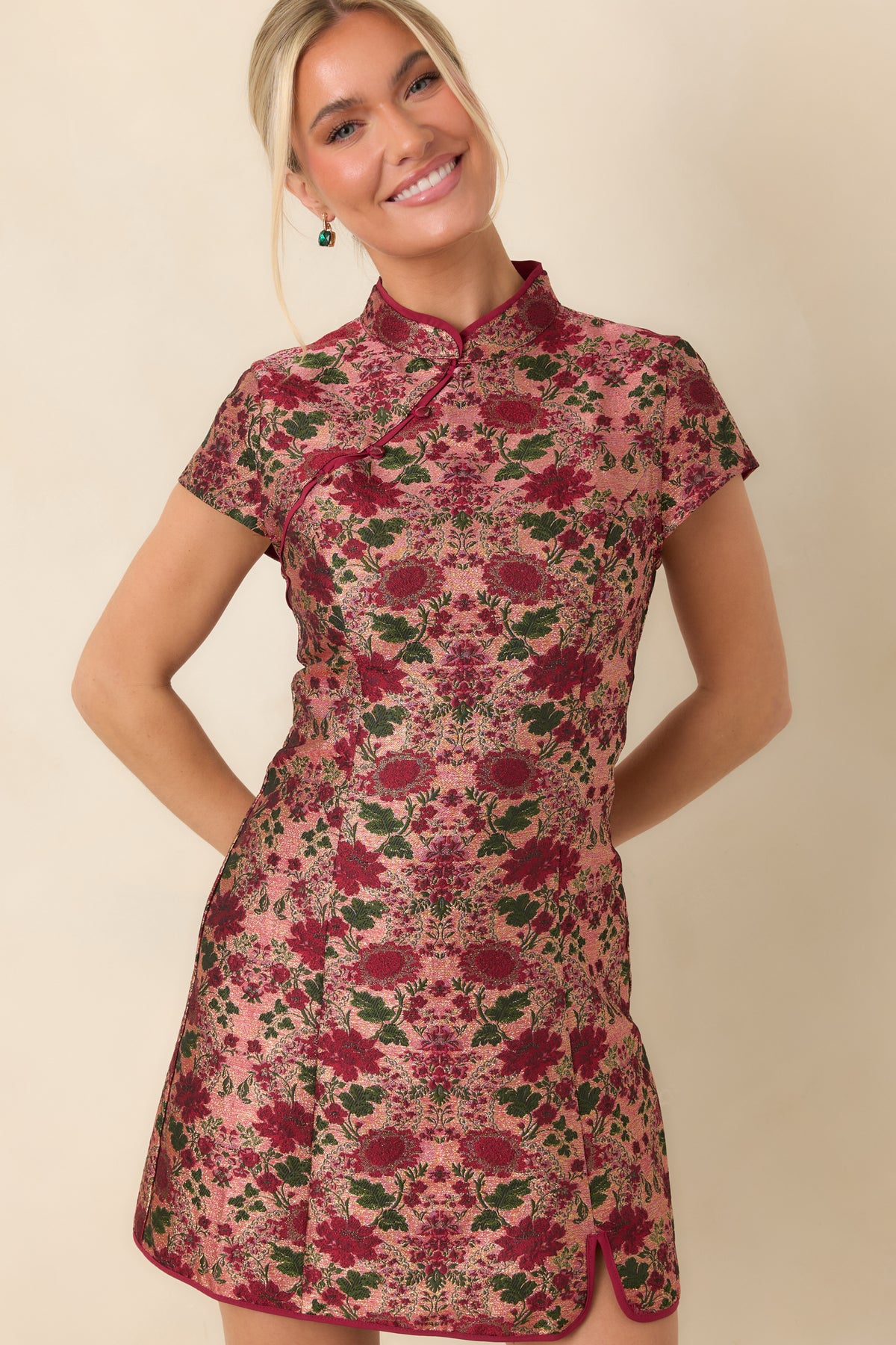 Burgundy blooms and deep green foliage decorate the textured jacquard bodice and short cap sleeves.