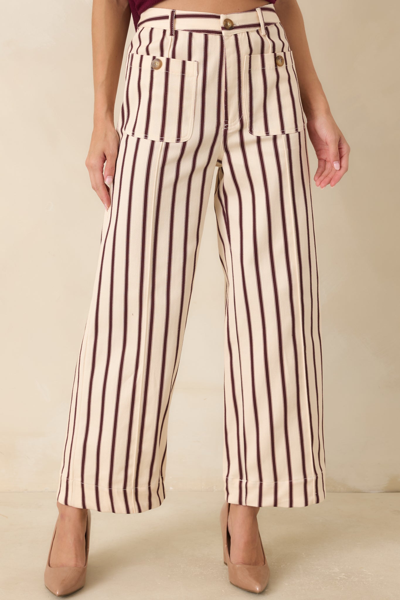 Front detail of the striped pants highlighting the smooth fabric texture, relaxed fit, and bold vertical pattern.