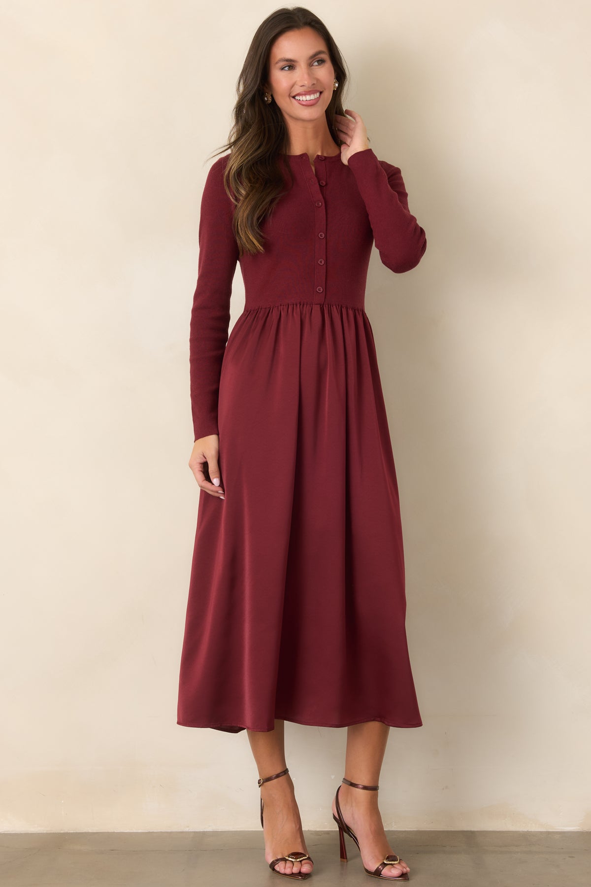 Burgundy knit and satin midi dress with tonal button detailing and a gently flared silhouette.