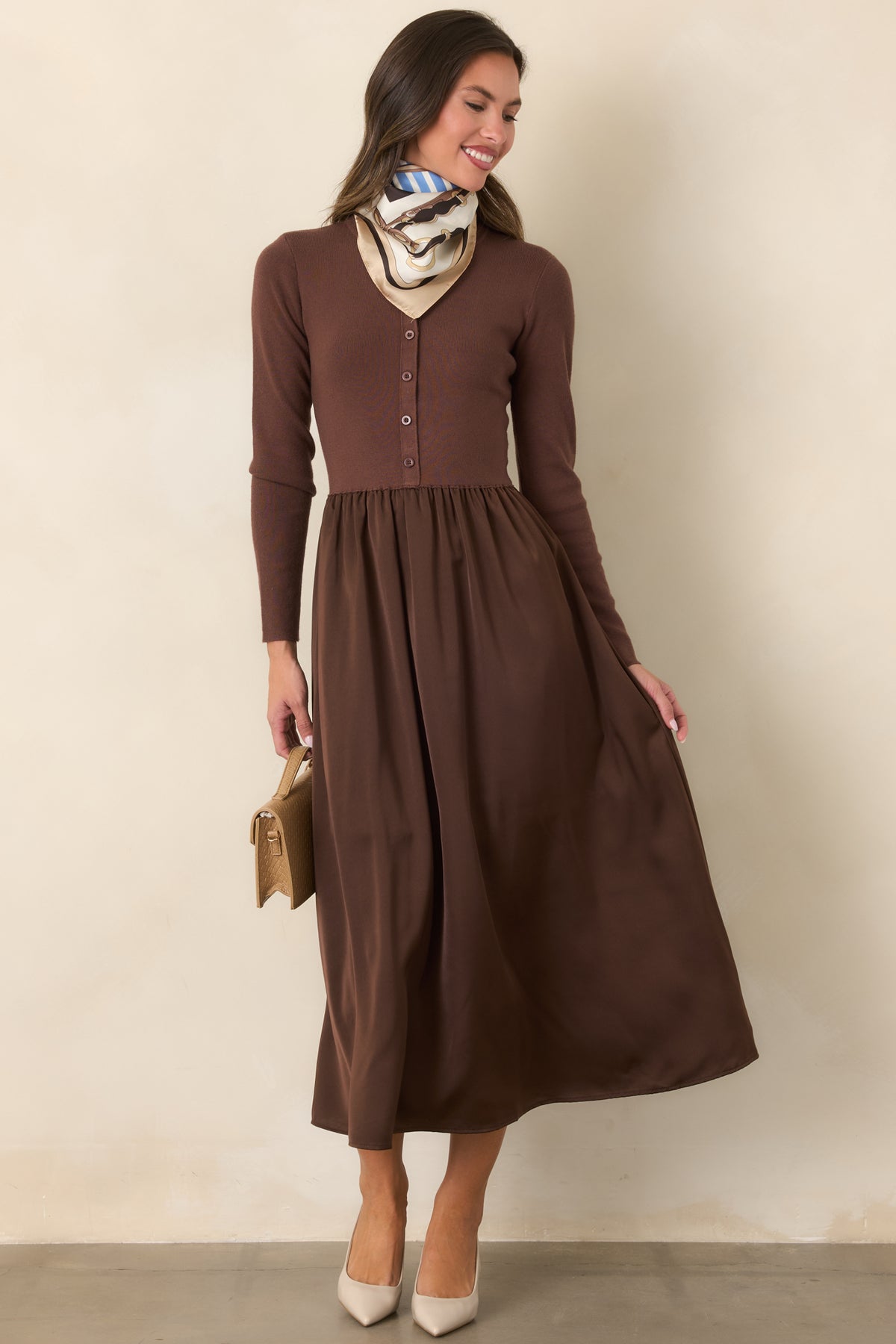 Burgundy midi dress with long sleeves and a gathered skirt that adds fluid movement.
