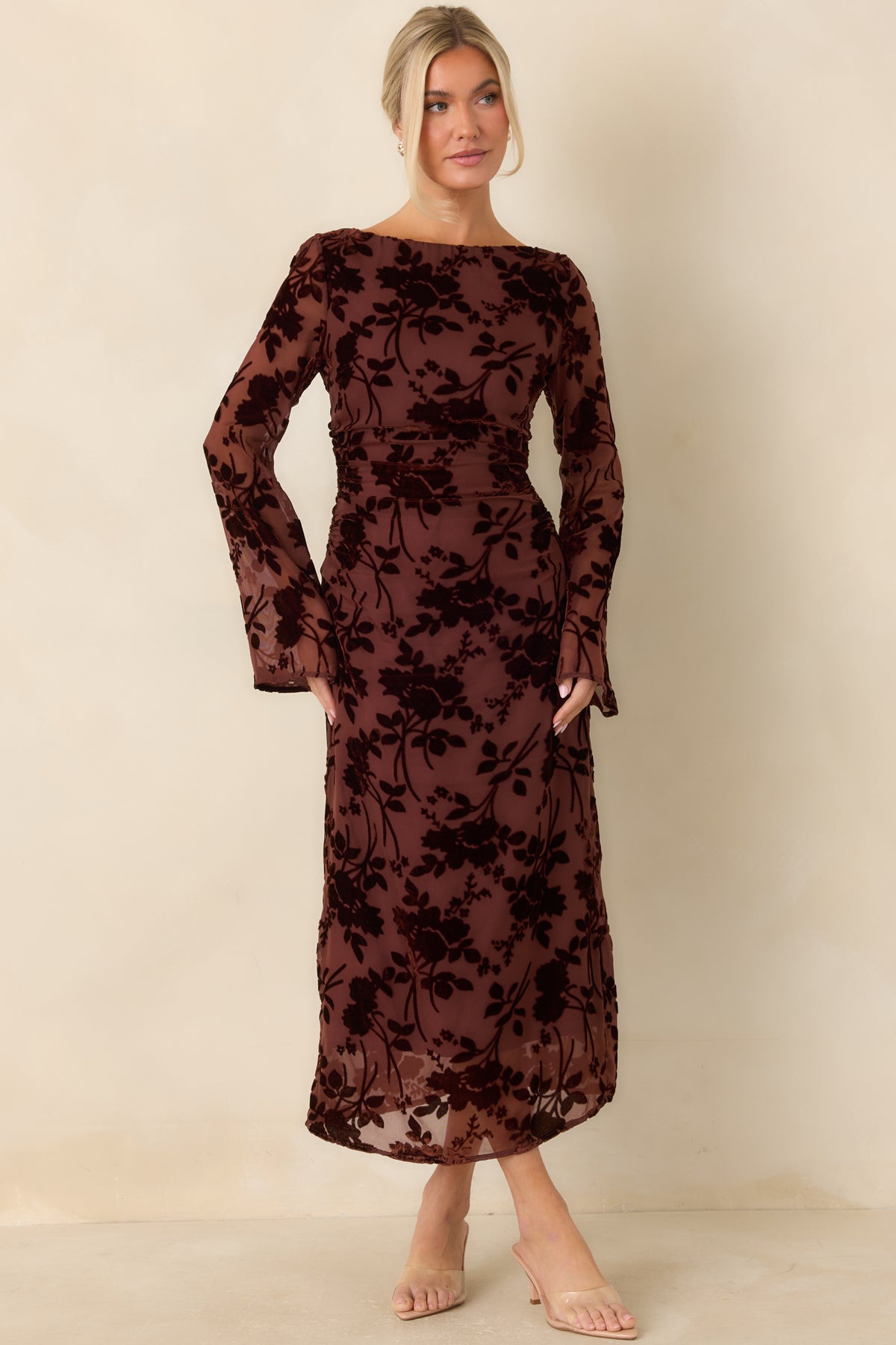 Burgundy midi dress with an allover floral burnout velvet pattern, sheer mesh sleeves, and a fitted silhouette.