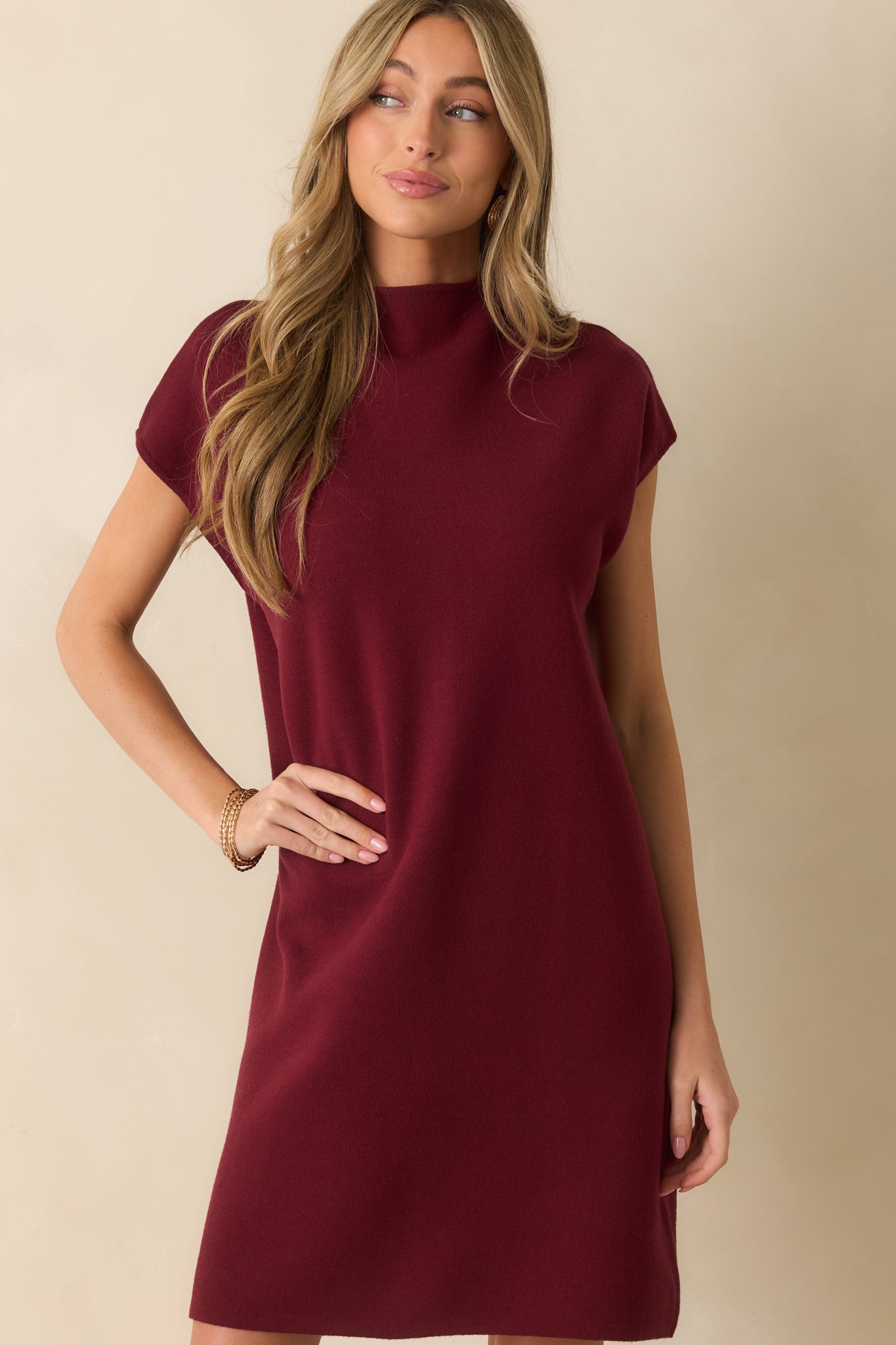 Focus on the upper portion of the burgundy mini dress, showing short sleeves and soft ribbed fabric.
