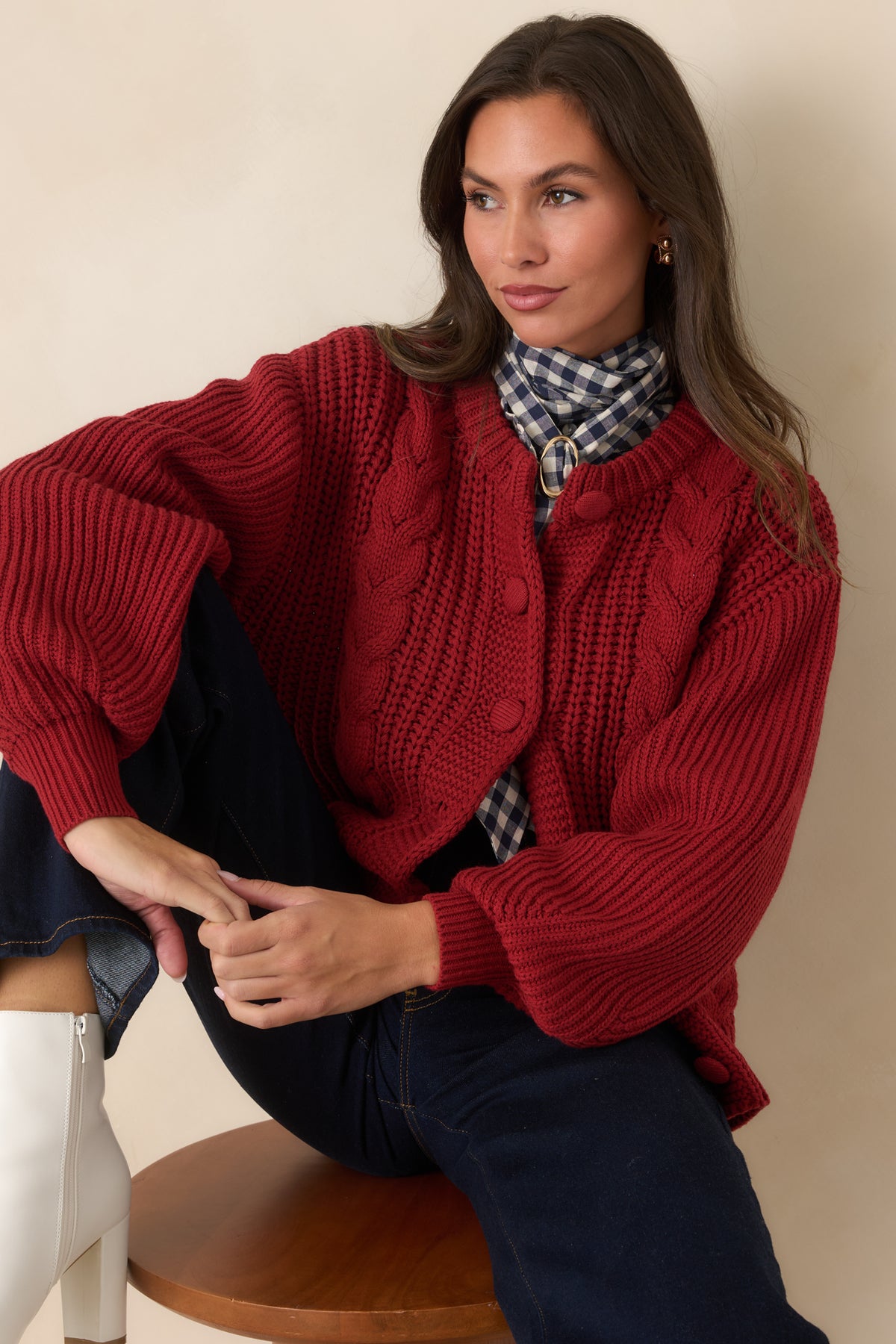 Burgundy cardigan featuring a ribbed hem that balances its relaxed silhouette.