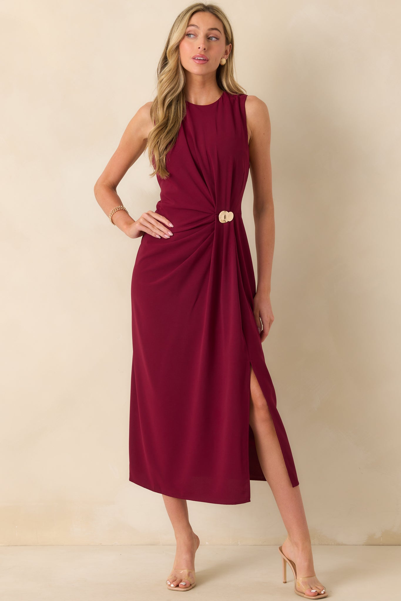 Burgundy sleeveless dress with a round neckline and ruched detailing down the front, shown in a full front view.