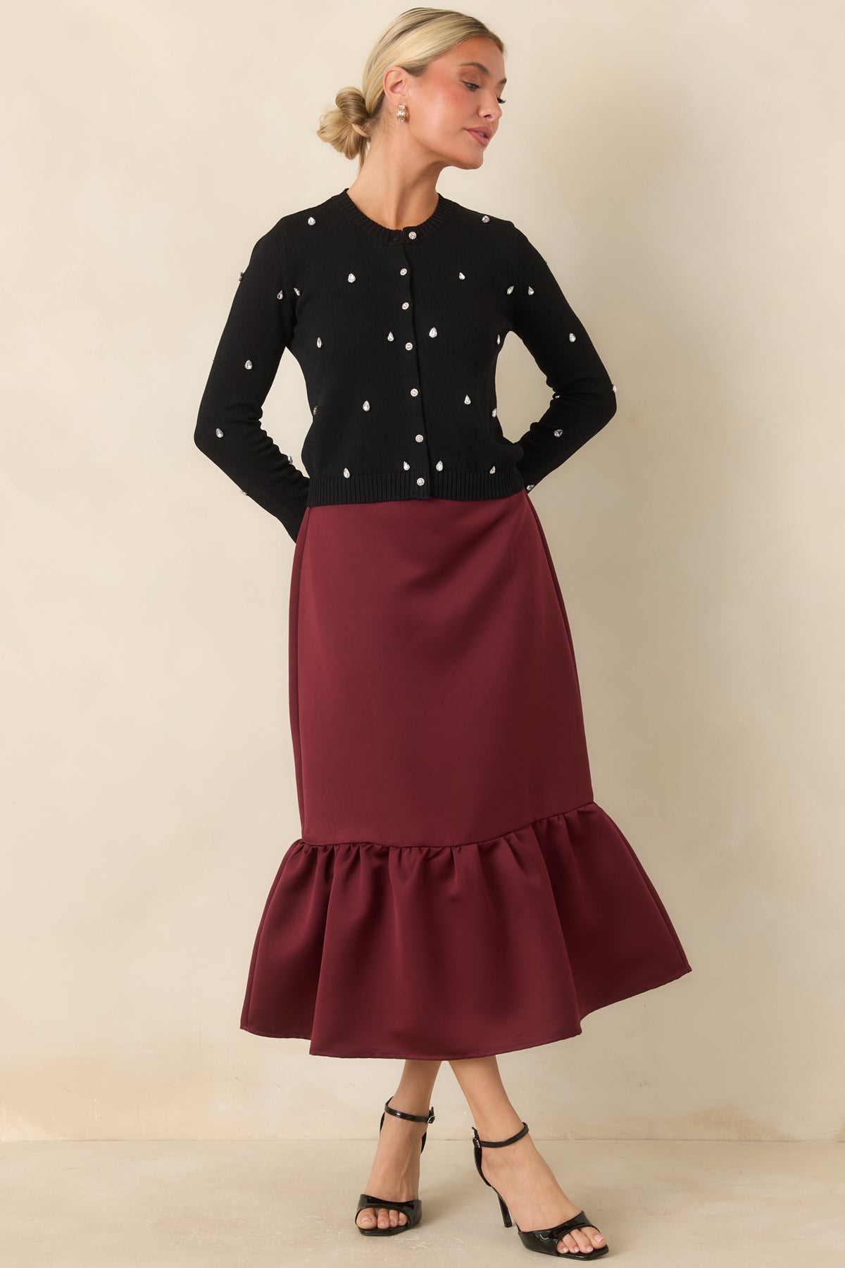 Rich burgundy midi skirt featuring a sleek satin finish and gathered flounce hem.