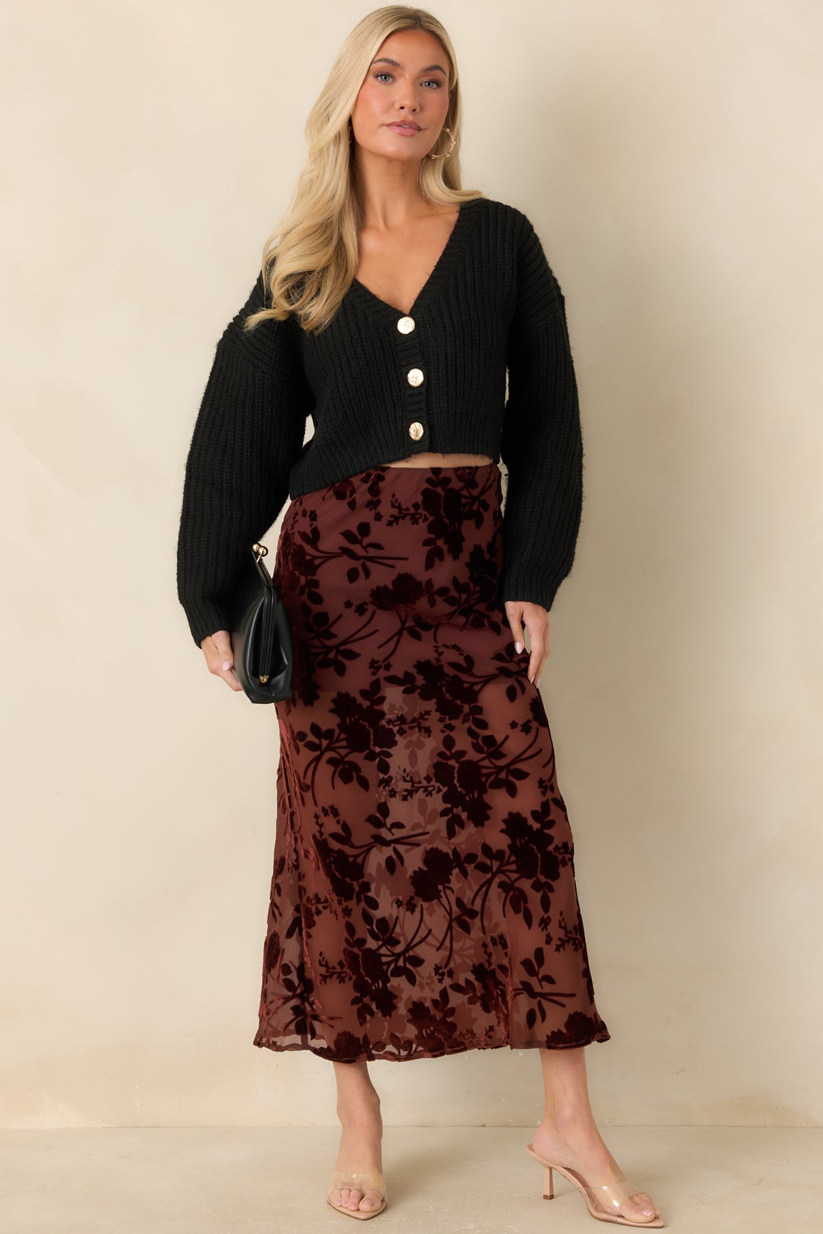 Rich burgundy velvet burnout skirt with a slim silhouette and flowing midi-length hem.