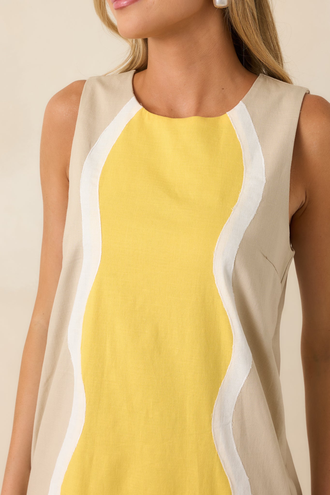 Close-up of the cotton blend fabric highlighting the butter yellow center panel, ivory wave detailing, and round neckline.