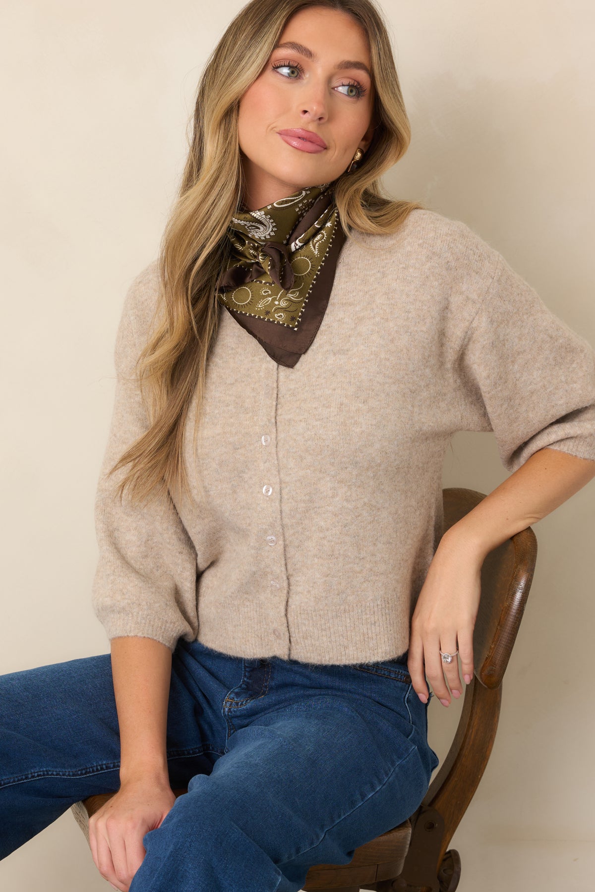 Button-front cardigan showcasing elbow-length sleeves and a clean ribbed hem.