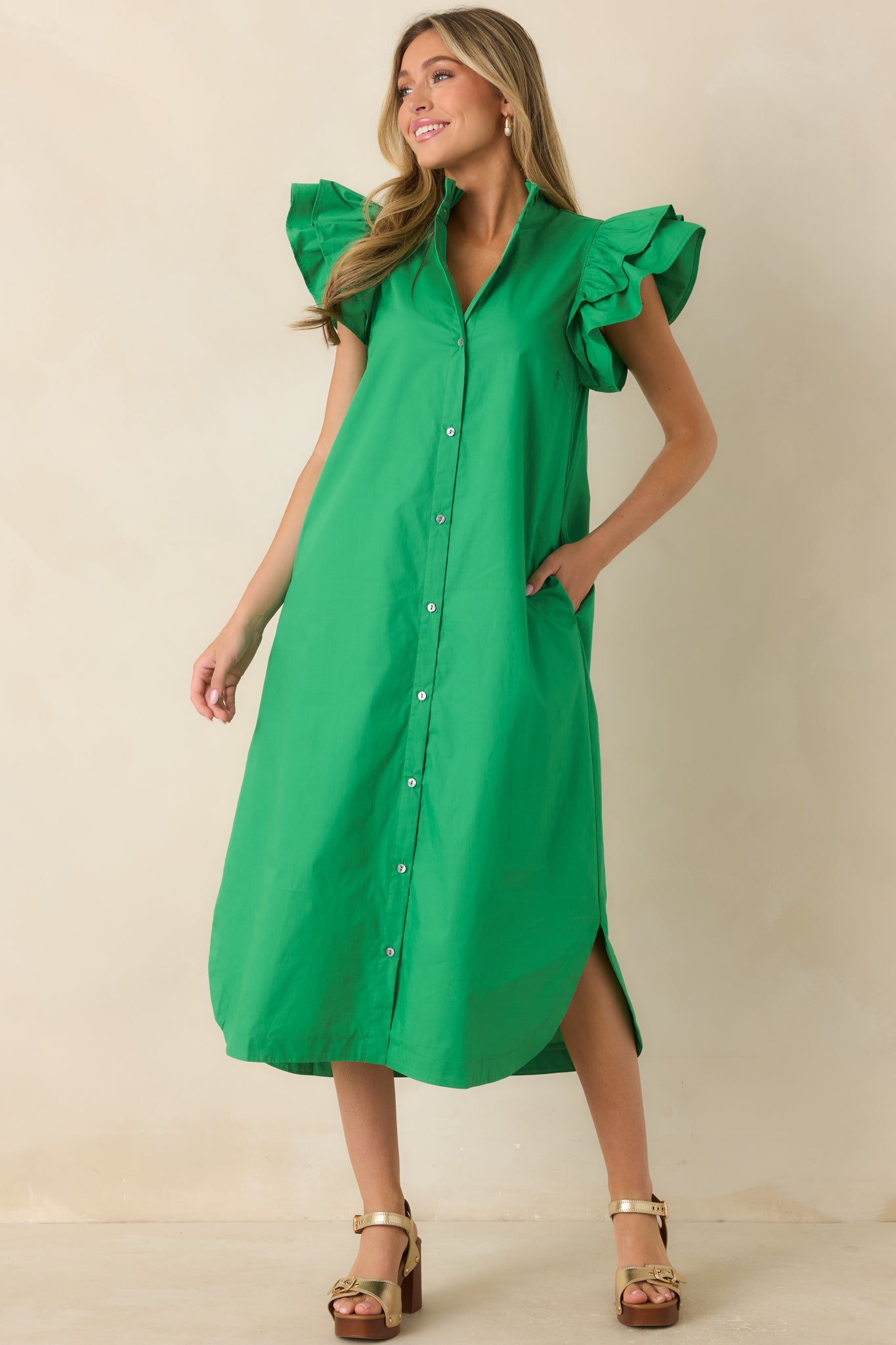Button-front cotton dress with a feminine ruffle neckline and lightweight flowing silhouette.