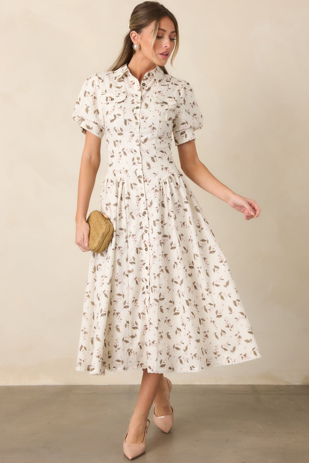 Button-front midi dress showcases short puff sleeves with buttoned cuffs and a softly gathered skirt with lace-trimmed hem.