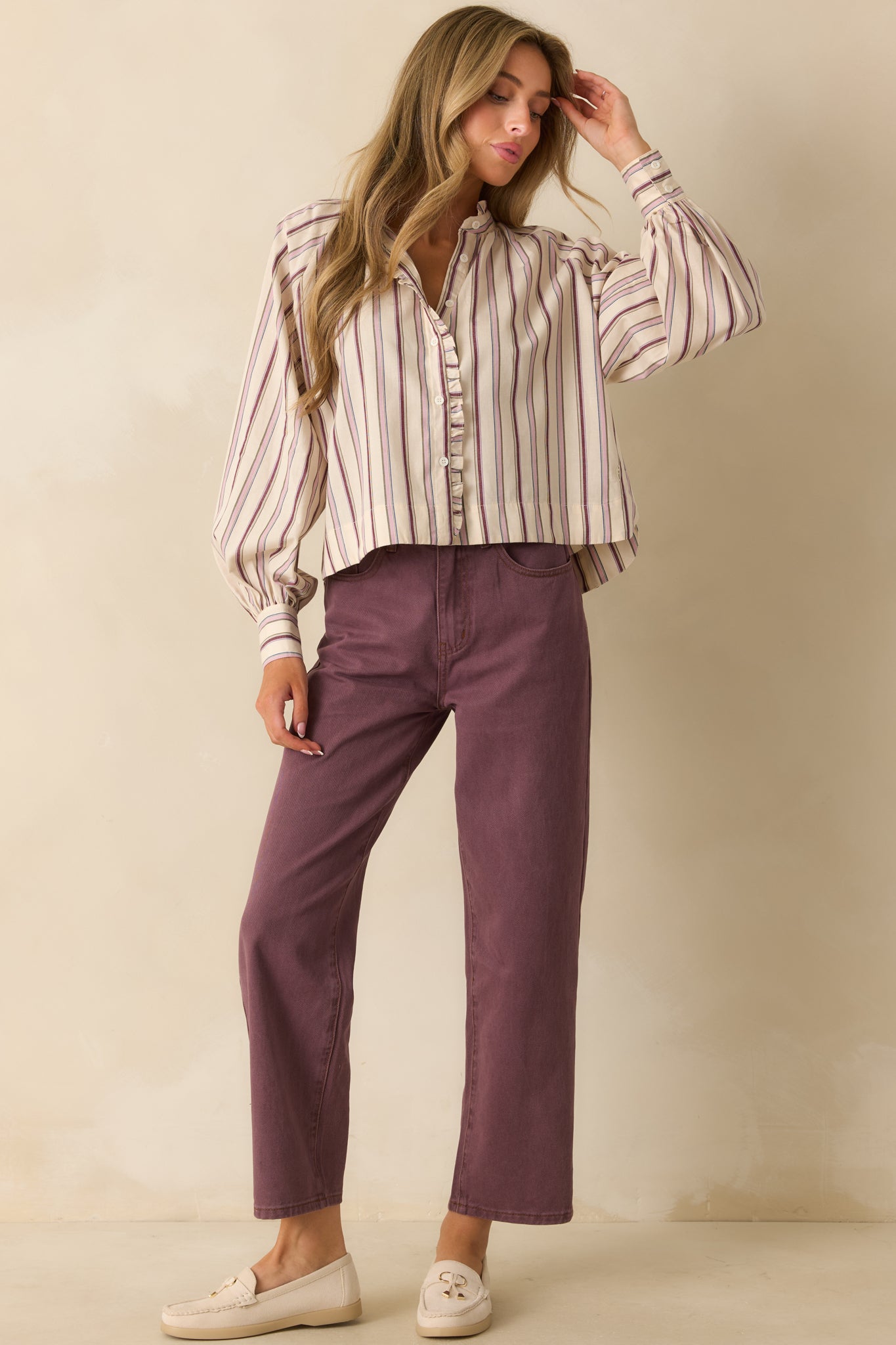 Buttoned ivory and lilac striped shirt displayed to show its elevated everyday style and loose silhouette.