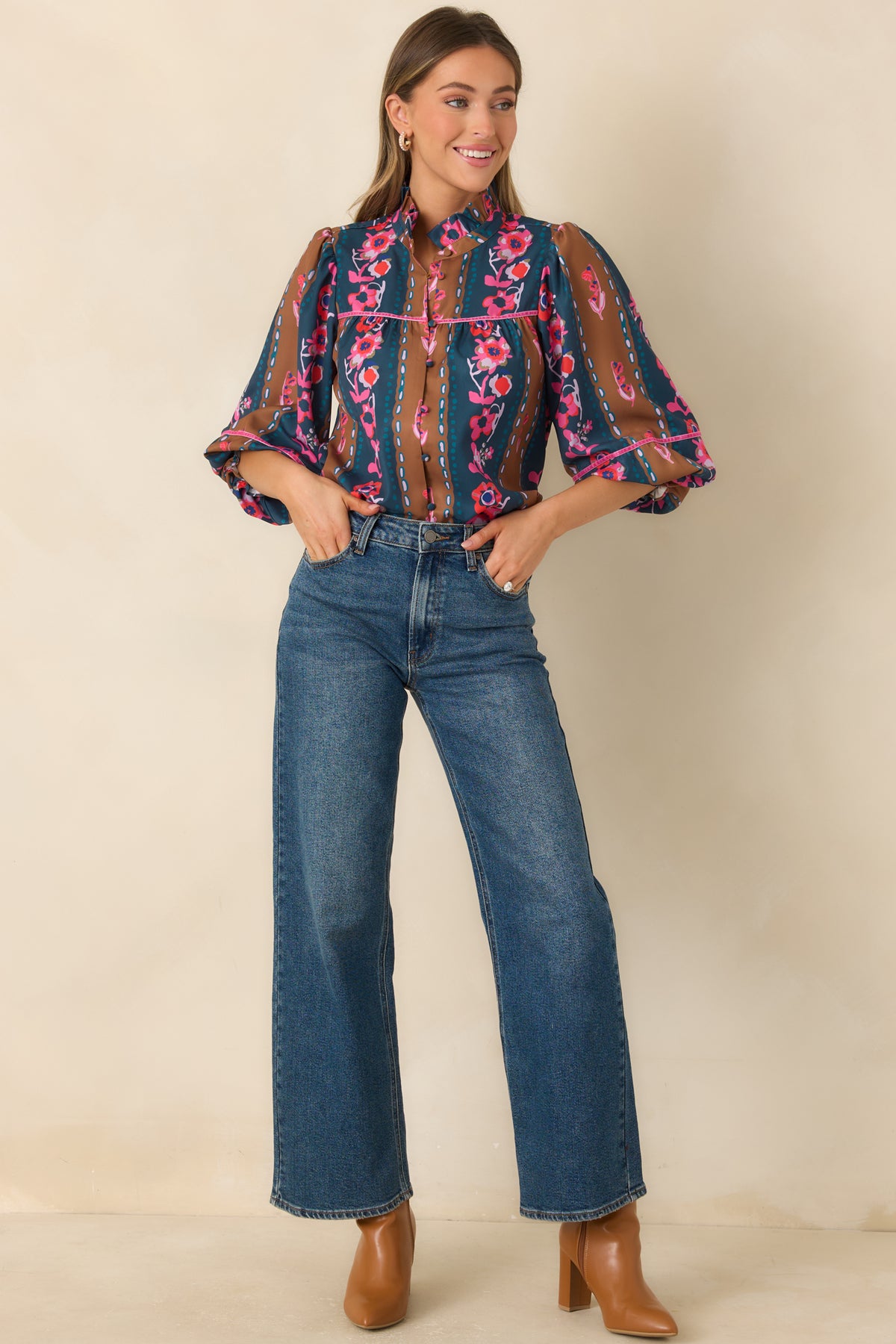 Floral striped top featuring a fabric-covered button front, pink trim, and voluminous balloon sleeves.