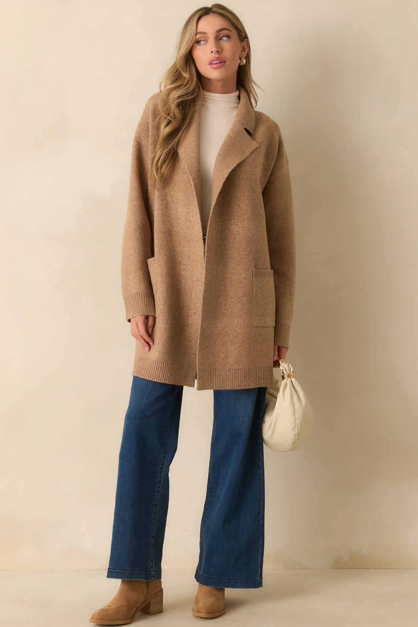 Camel brown knit cardigan with notched lapel collar, open front design, and drop shoulders.