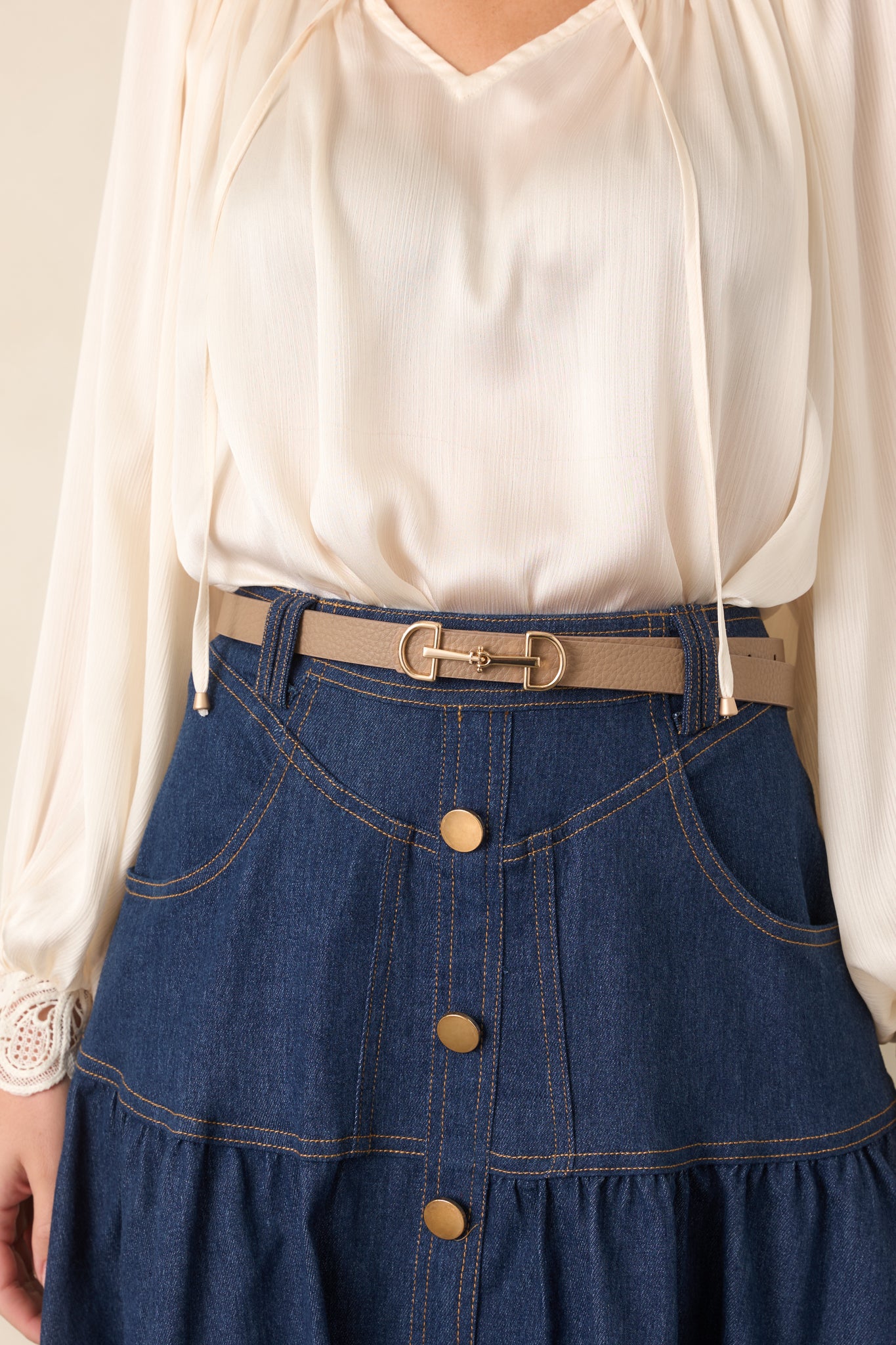 Camel brown faux leather belt with a textured finish, distinctive anchor buckle closure, and polished gold hardware.