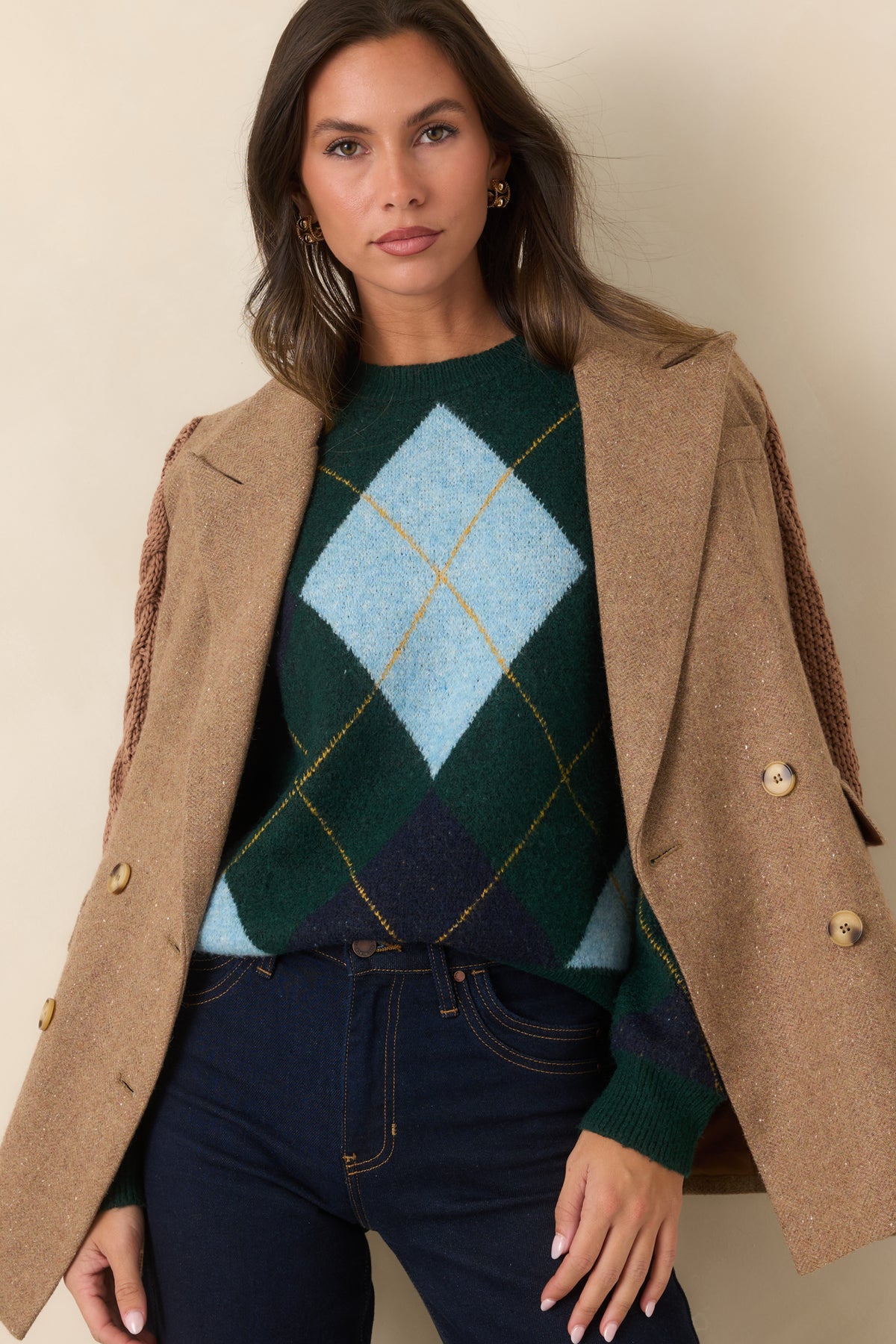 Contrasting cable-knit sleeve with ribbed cuff and striped detailing on the camel blazer.