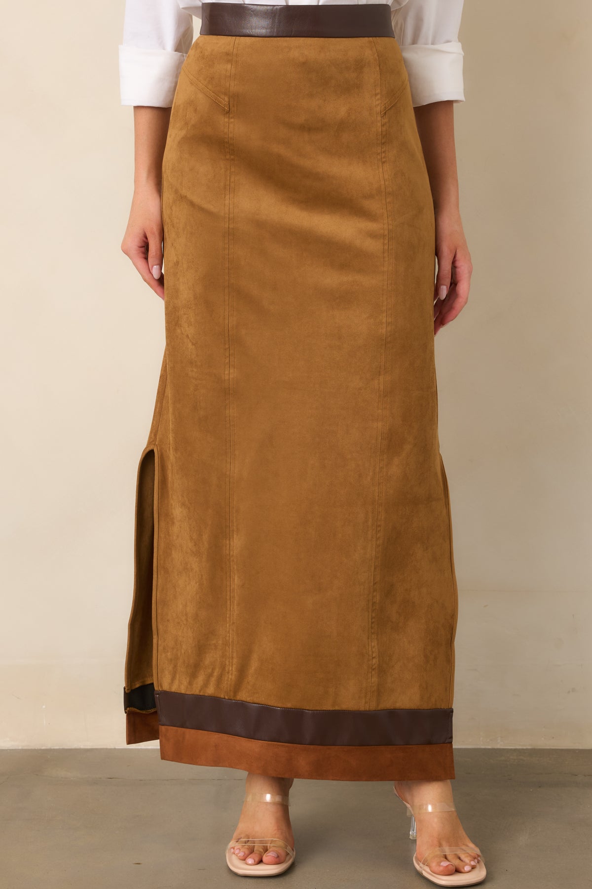 Camel faux suede skirt highlighting the chocolate brown waistband trim and vertical seam detailing.