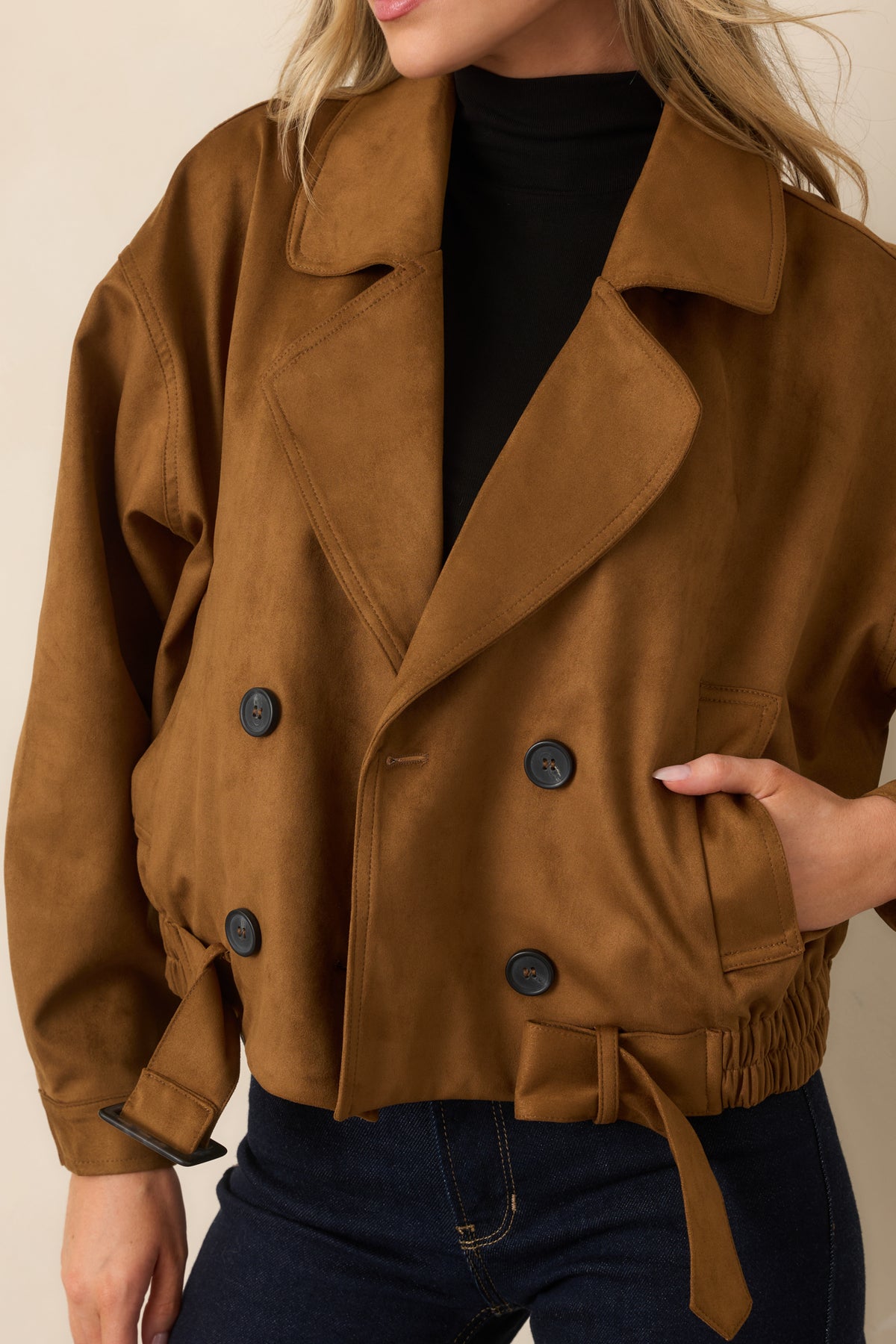 Camel faux suede trench coat highlighting the button closures and wide lapel collar.