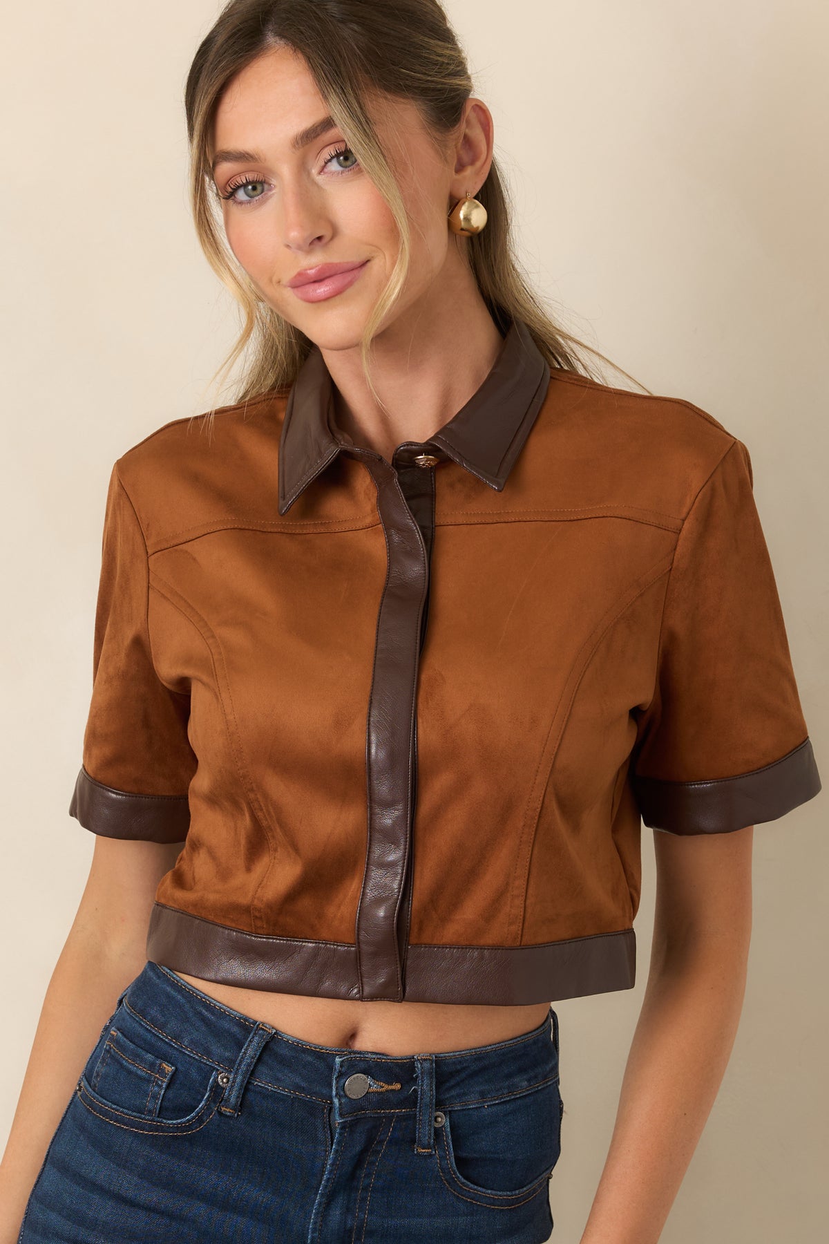 Camel faux suede top highlighting the pointed collar and chocolate brown trim around the neckline.