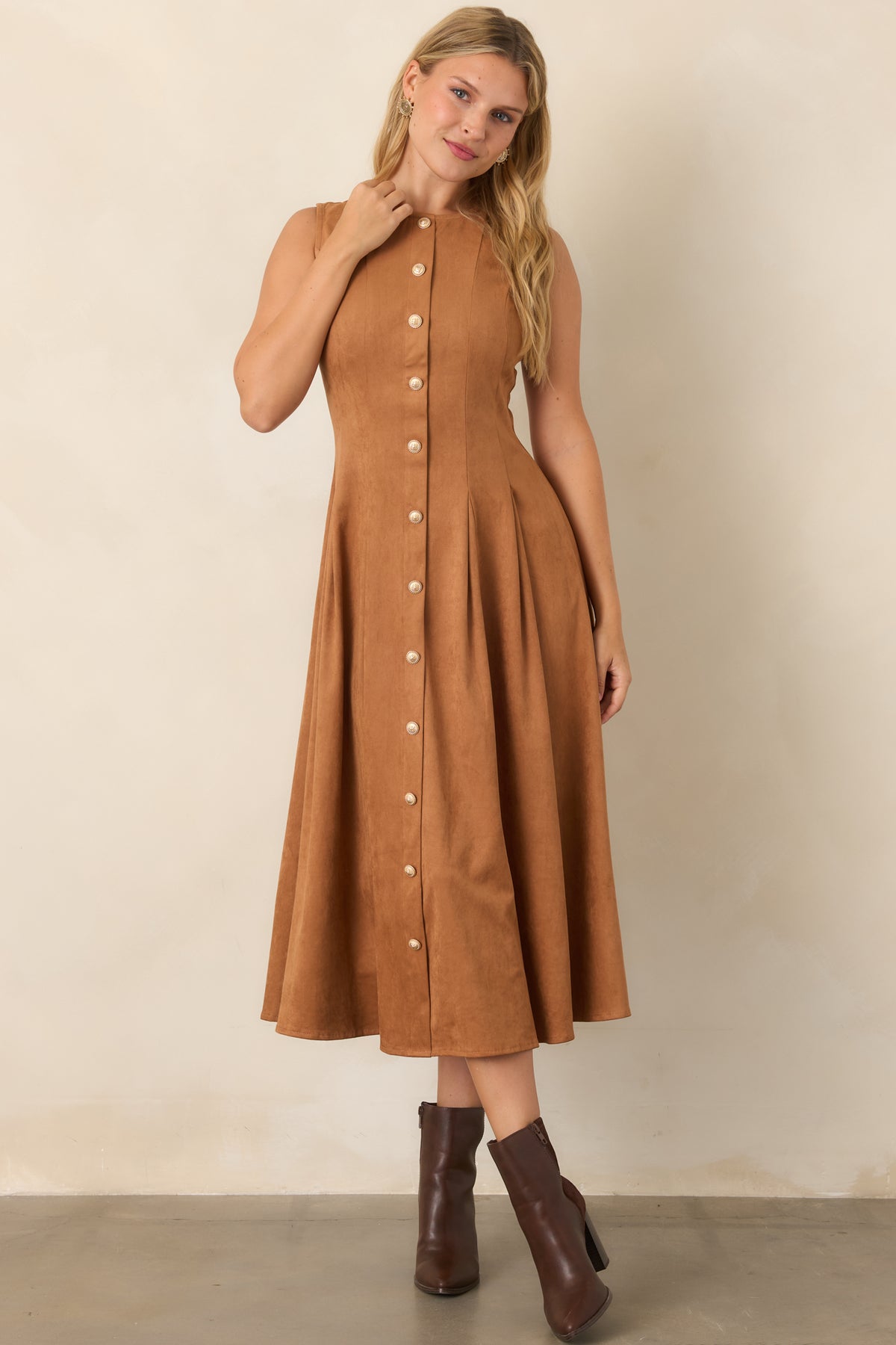 Faux suede midi dress in camel with a round neckline, fitted bodice, defined princess seams, sleeveless construction, and full pleated skirt.