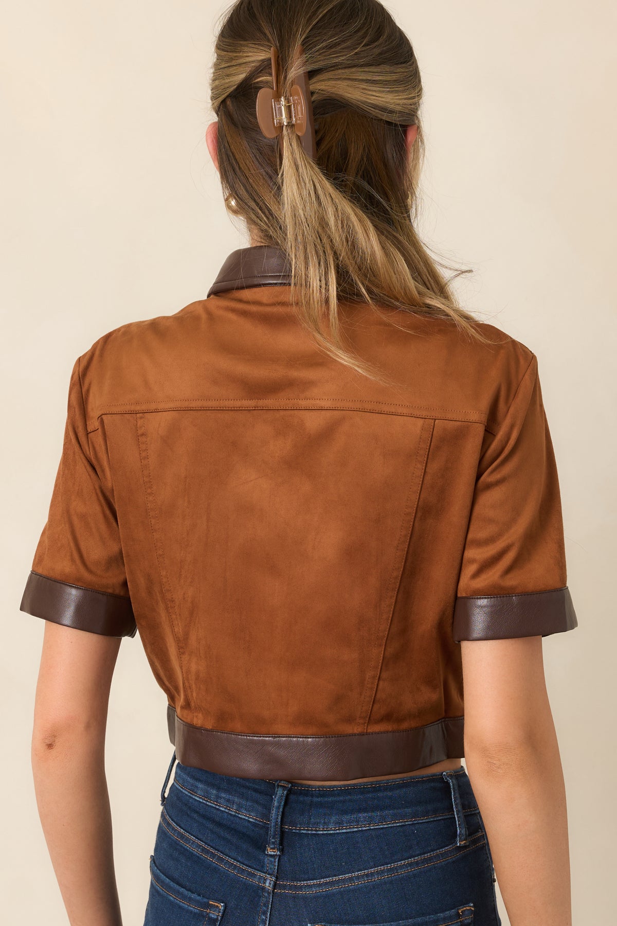 Rear of the camel faux suede top with shaped seams and chocolate brown faux leather hem trim.