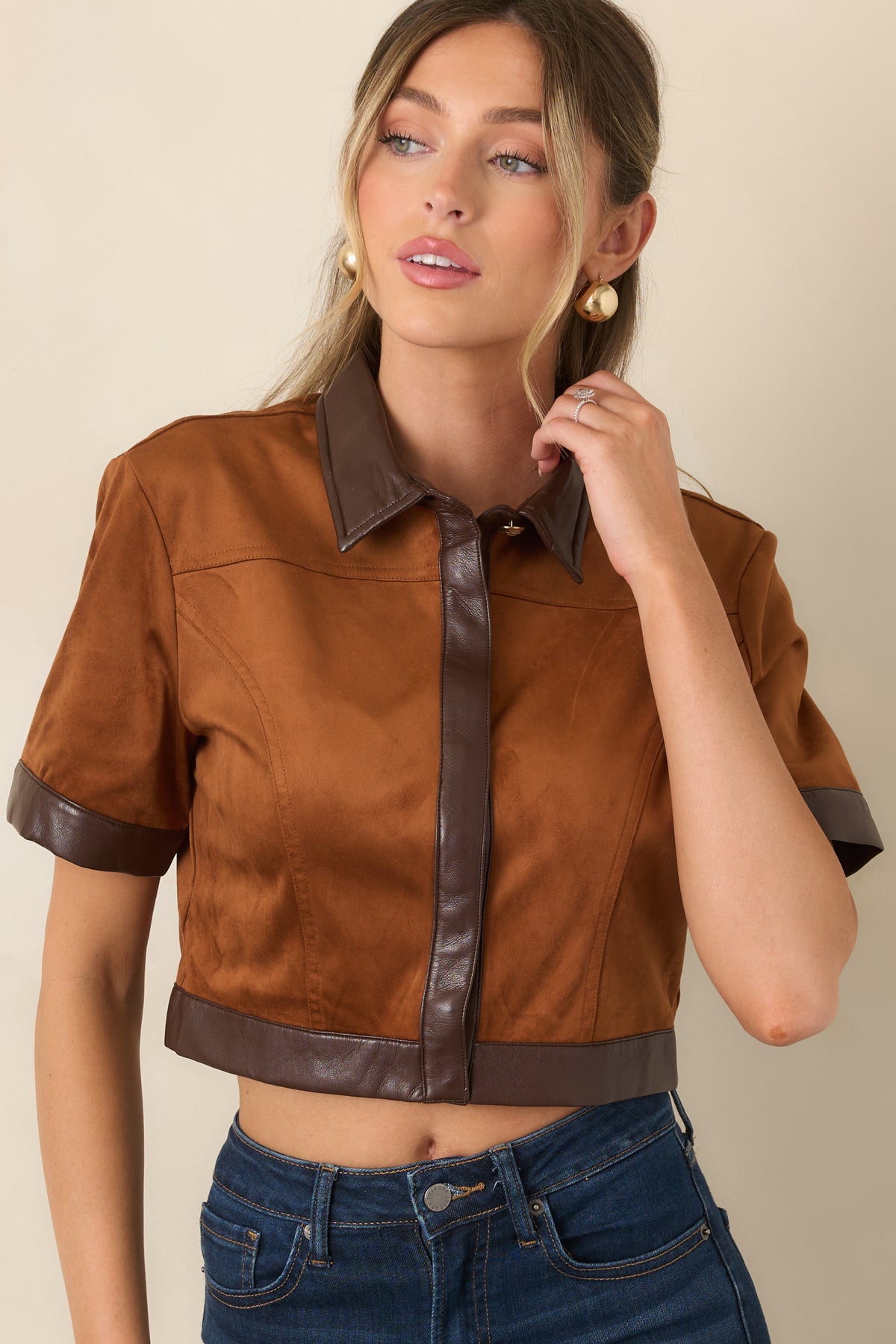 Camel faux suede top showing short sleeves finished with contrasting chocolate brown faux leather trim.