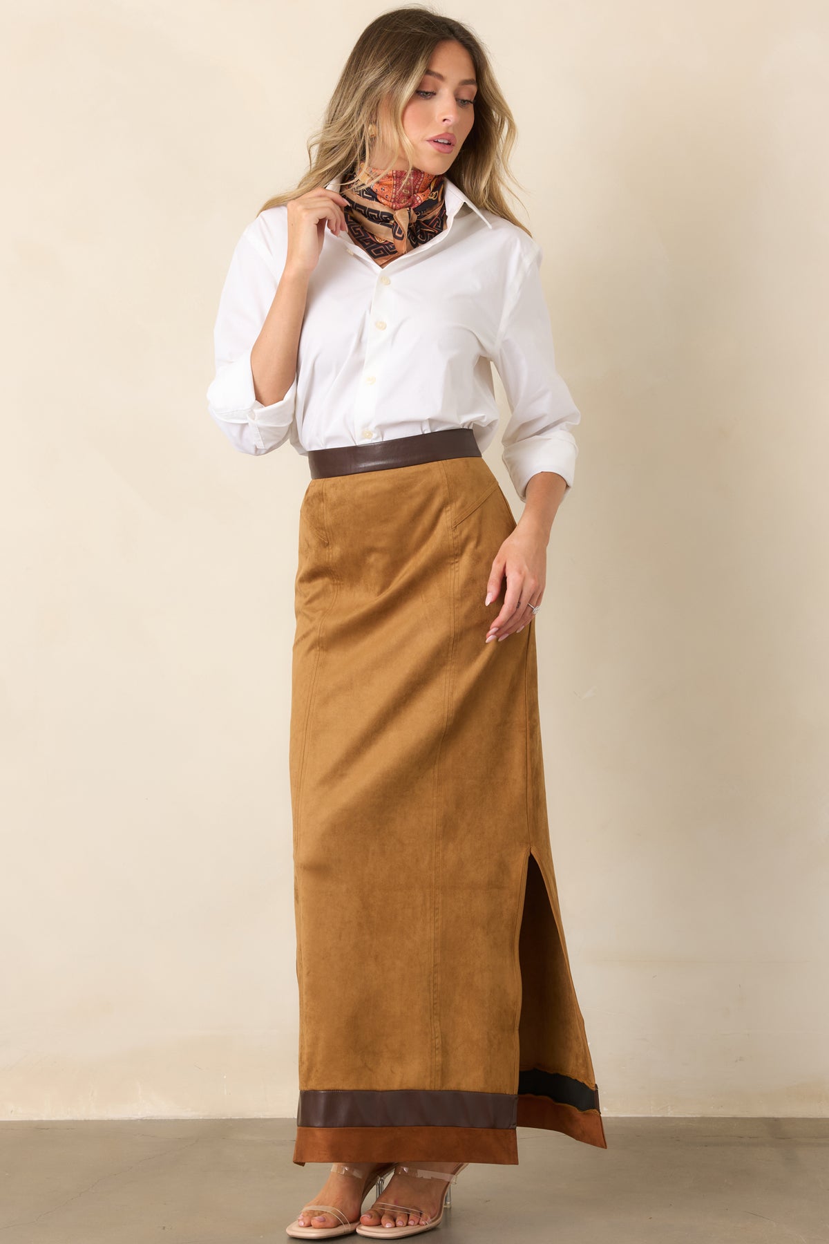 Straight camel faux suede skirt accented by chocolate brown trim and movement-enhancing side slits.