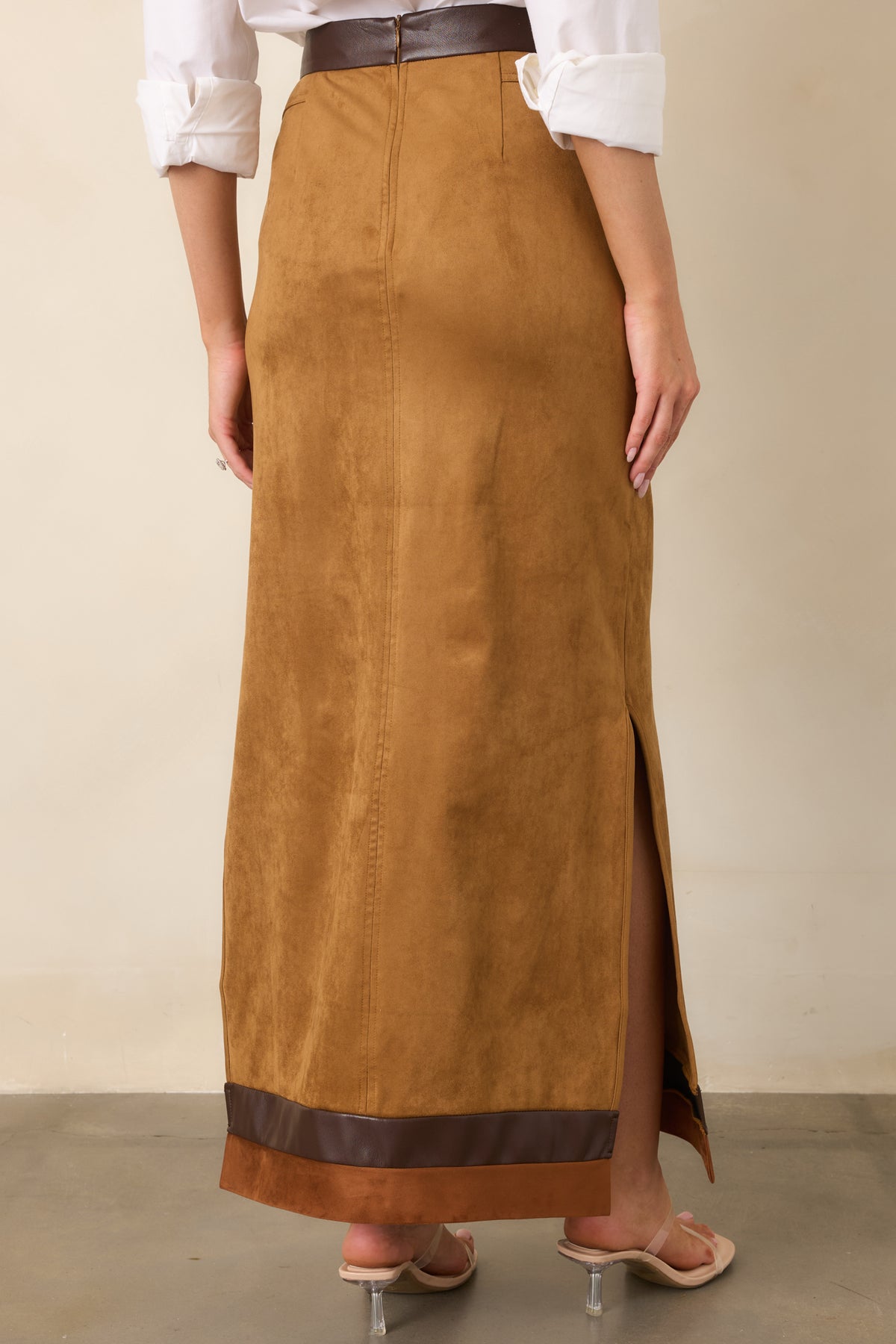 Rear of the camel faux suede maxi skirt showing vertical seams, contrast trim, and back zipper.