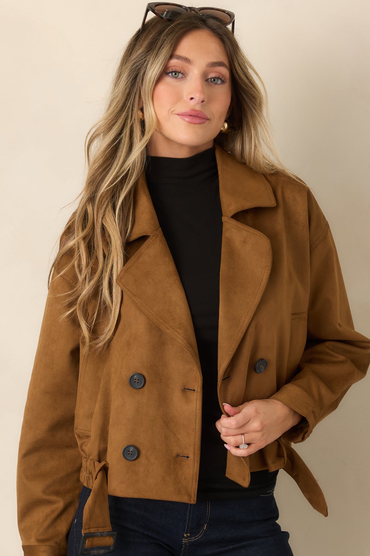 Camel faux suede trench coat highlighting the wide lapel collar and double-breasted front.
