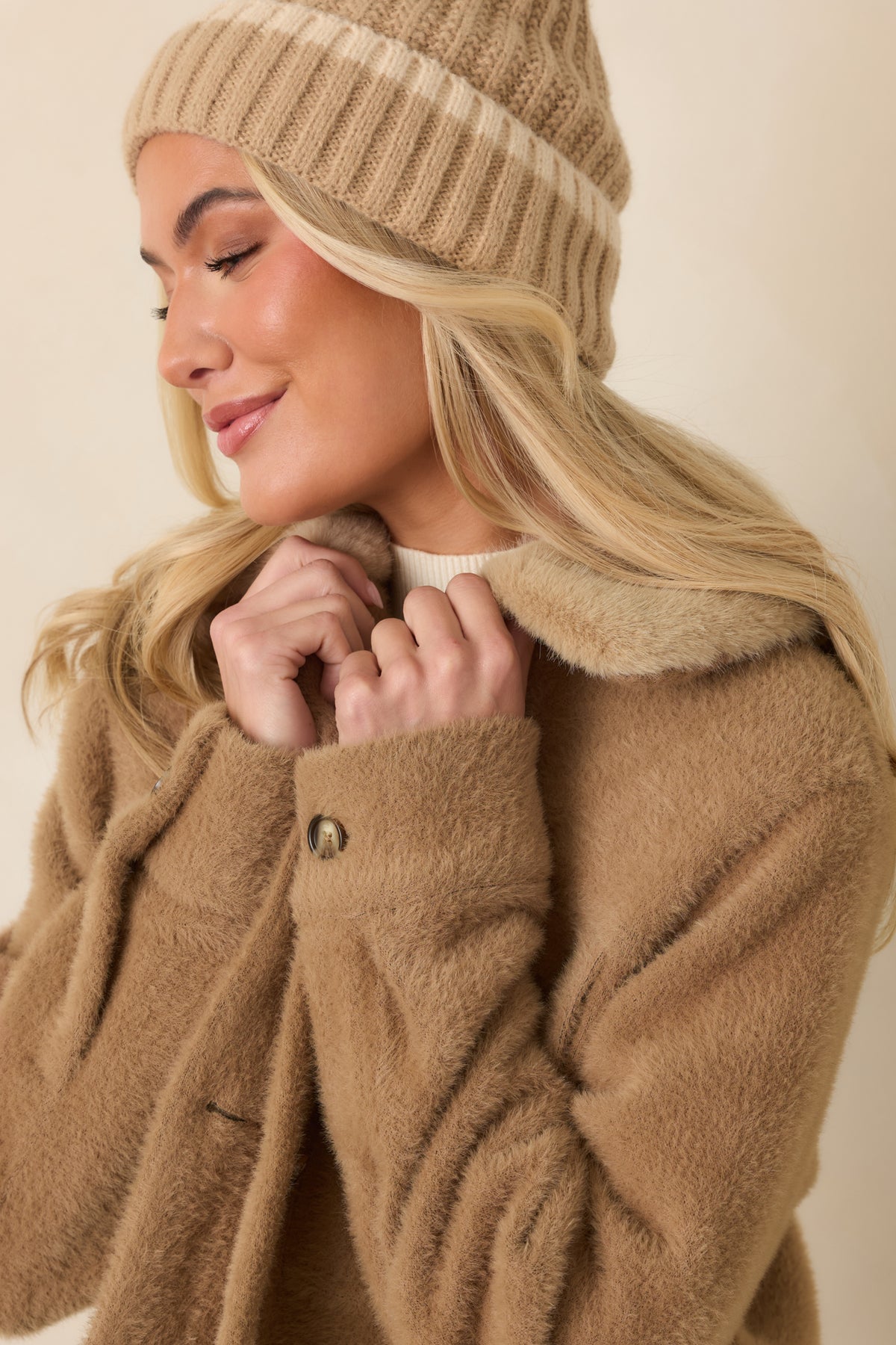 Close-up of the tonal faux fur collar against the brushed camel fabric of the jacket.