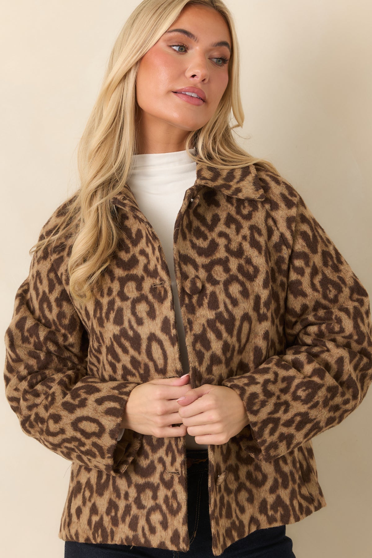 Long sleeves and a relaxed shoulder line complement the boxy silhouette of the leopard print layer.