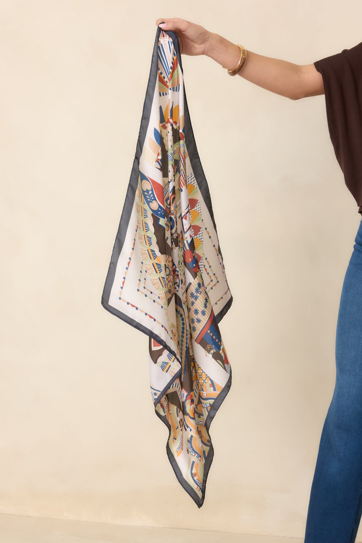 Scarf showcasing geometric patterns in camel, terracotta, and dusty blue with olive and ivory accents.
