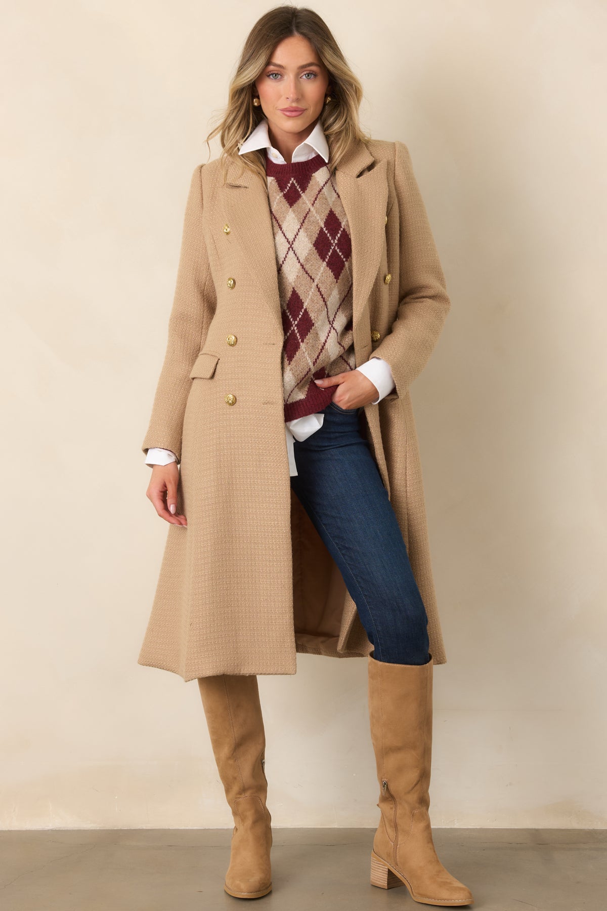 This textured woven topcoat features a clean tailored shape, double-breasted closure, and functional flap pockets.