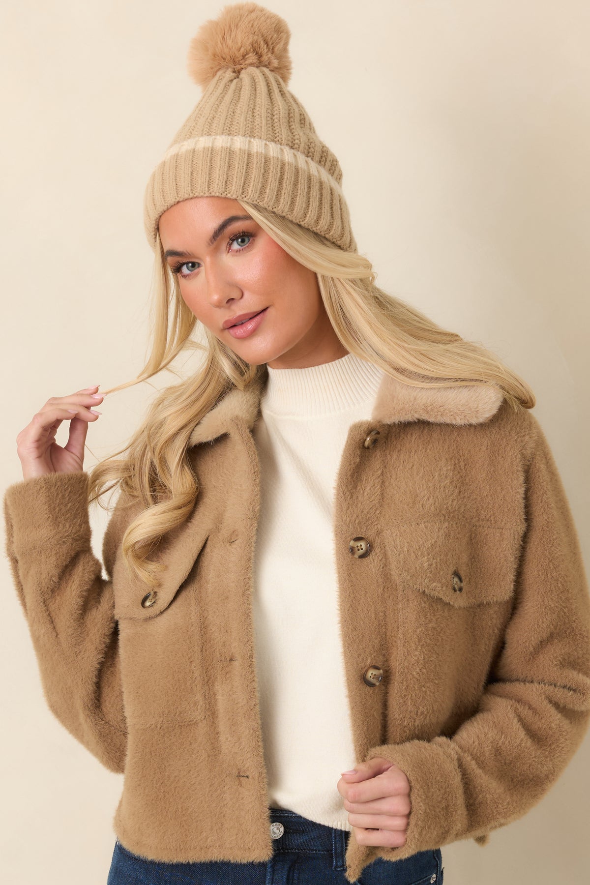 Softly textured camel fabric highlights the relaxed shape and structured front of the utility jacket.