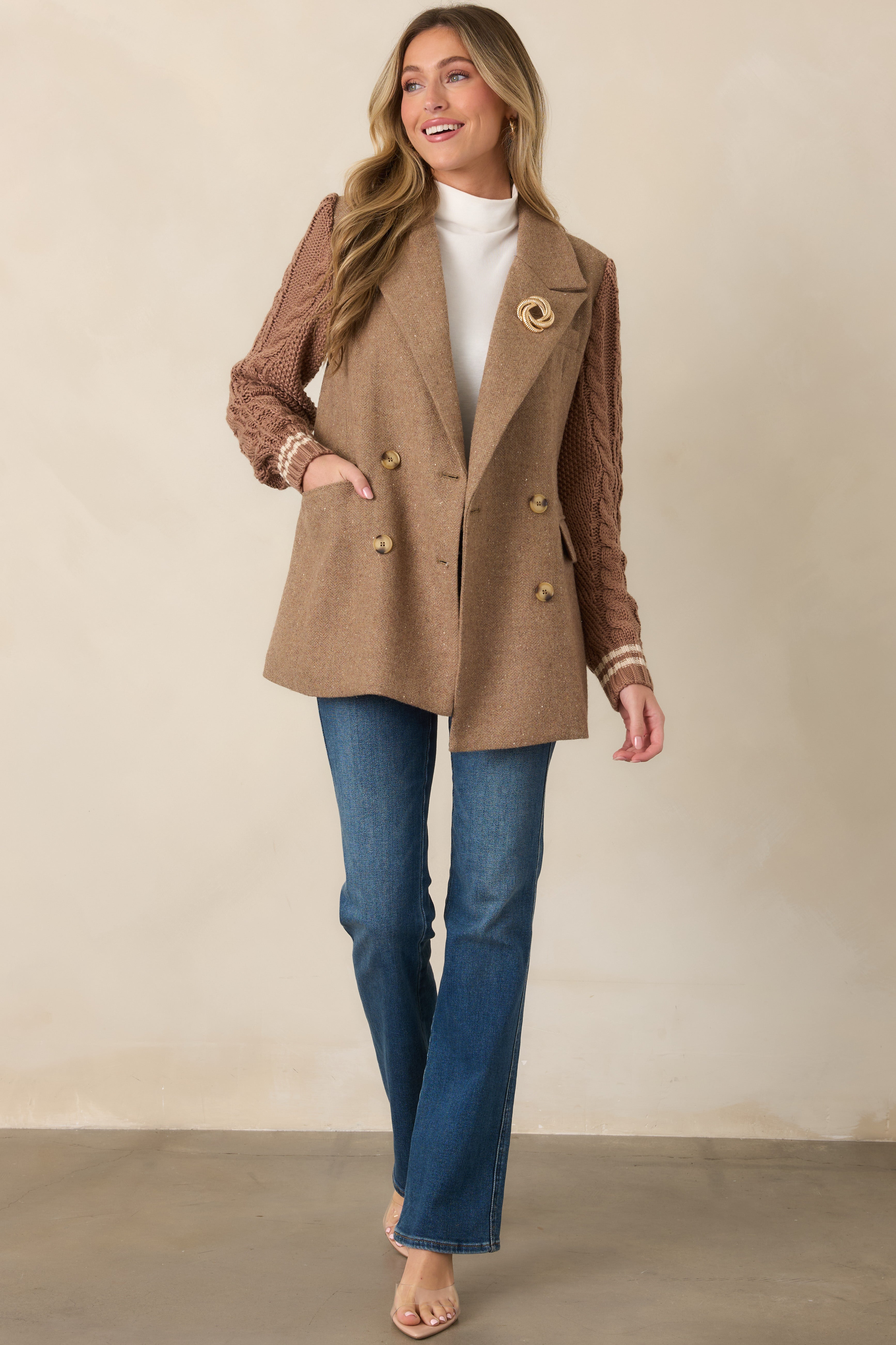 Camel wool-blend blazer with a polished double-breasted front, notched lapels, flap pockets, and contrasting cable-knit sleeves with striped cuffs.