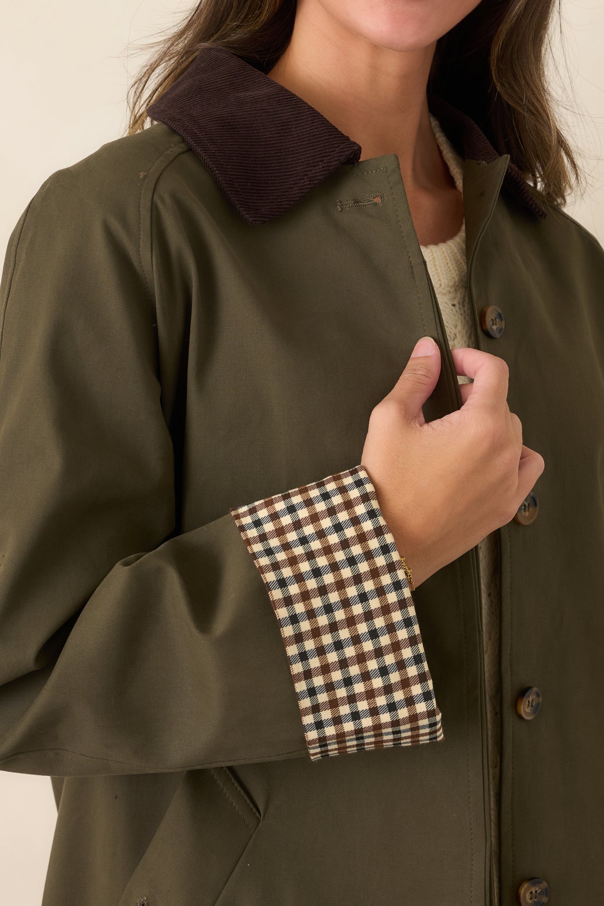 Close-up of the coat showing its button-front closure and textured corduroy collar.