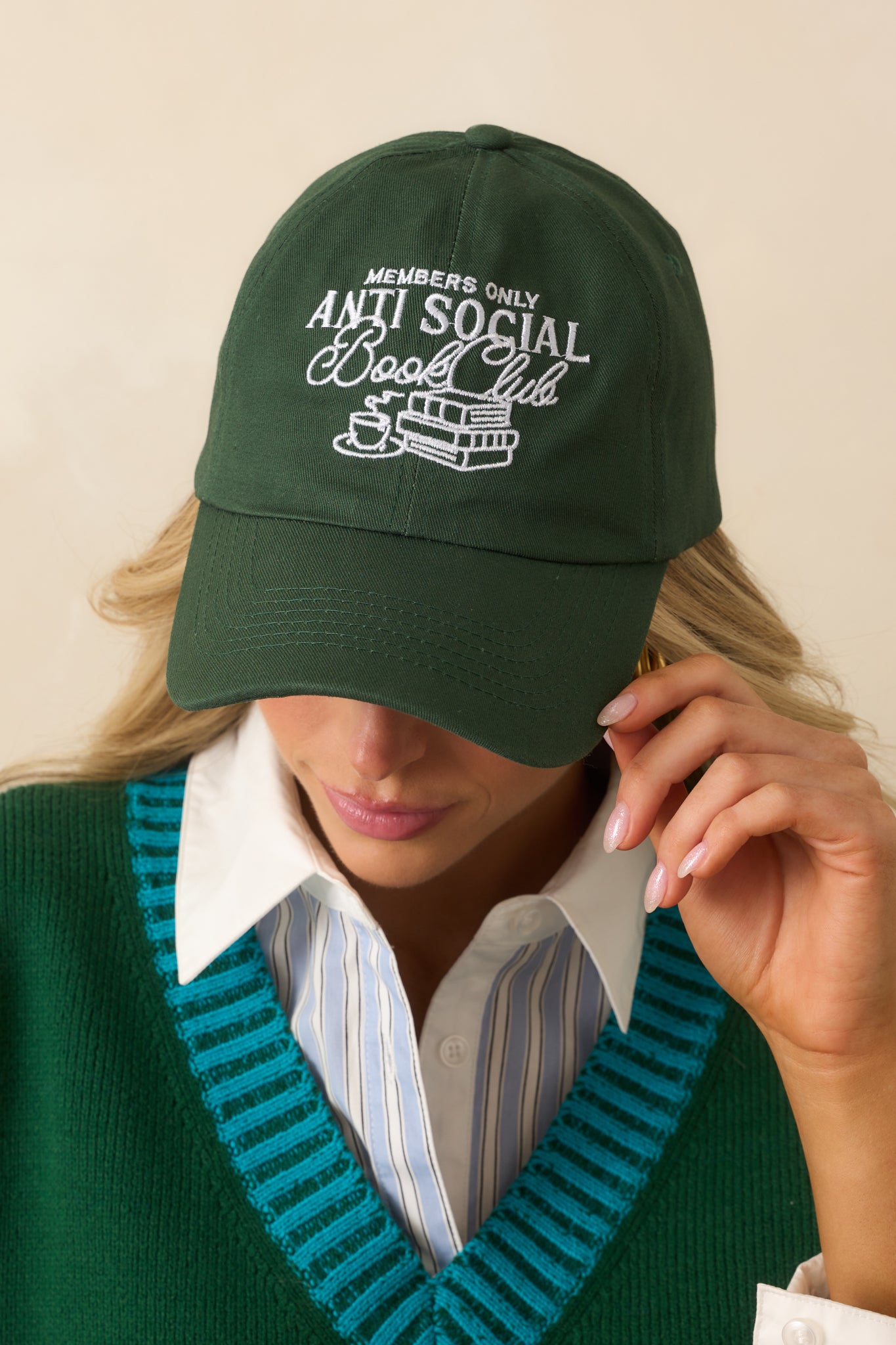 A cropped front view highlighting the white embroidered “Anti Social Book Club” graphic with stacked books and coffee cup detail.